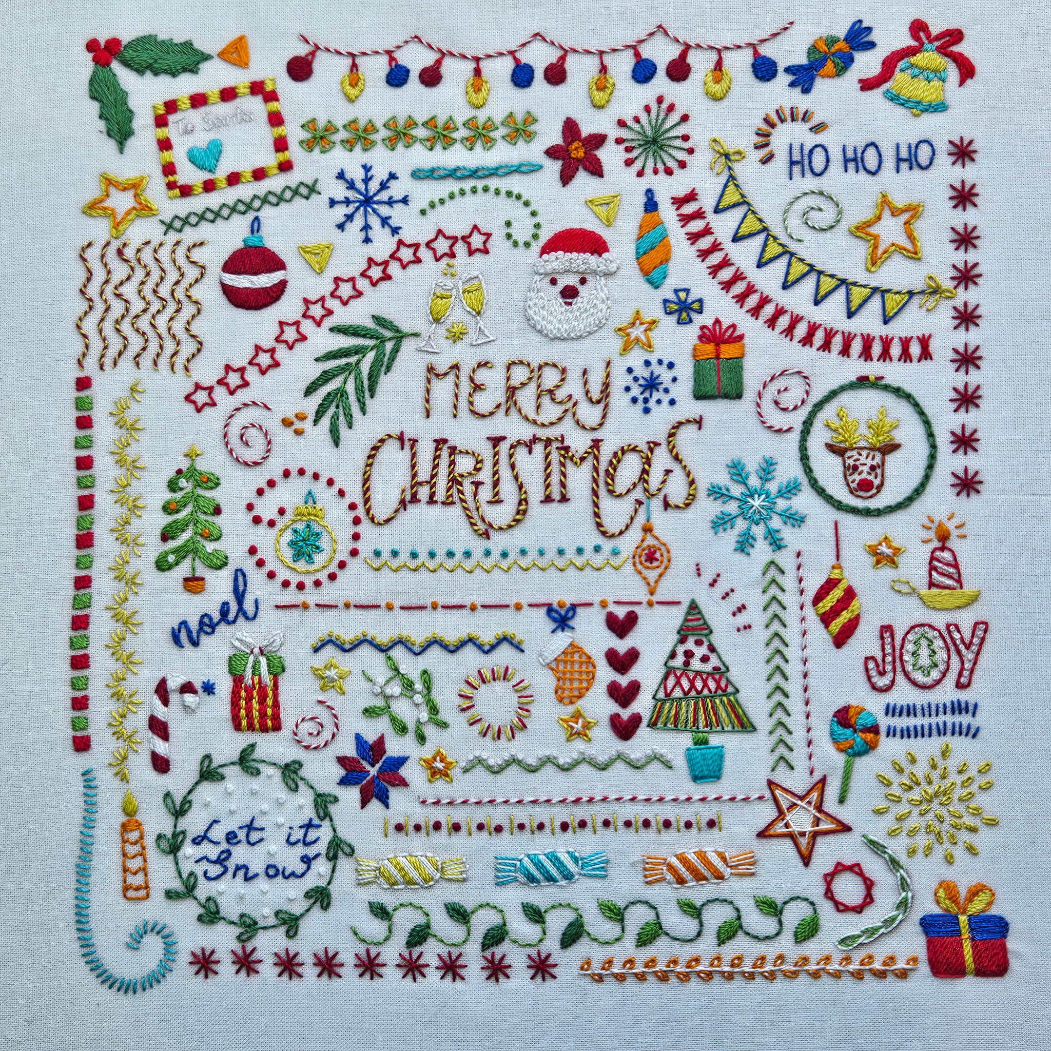 Embroidered Christmas design with various festive elements on a white background