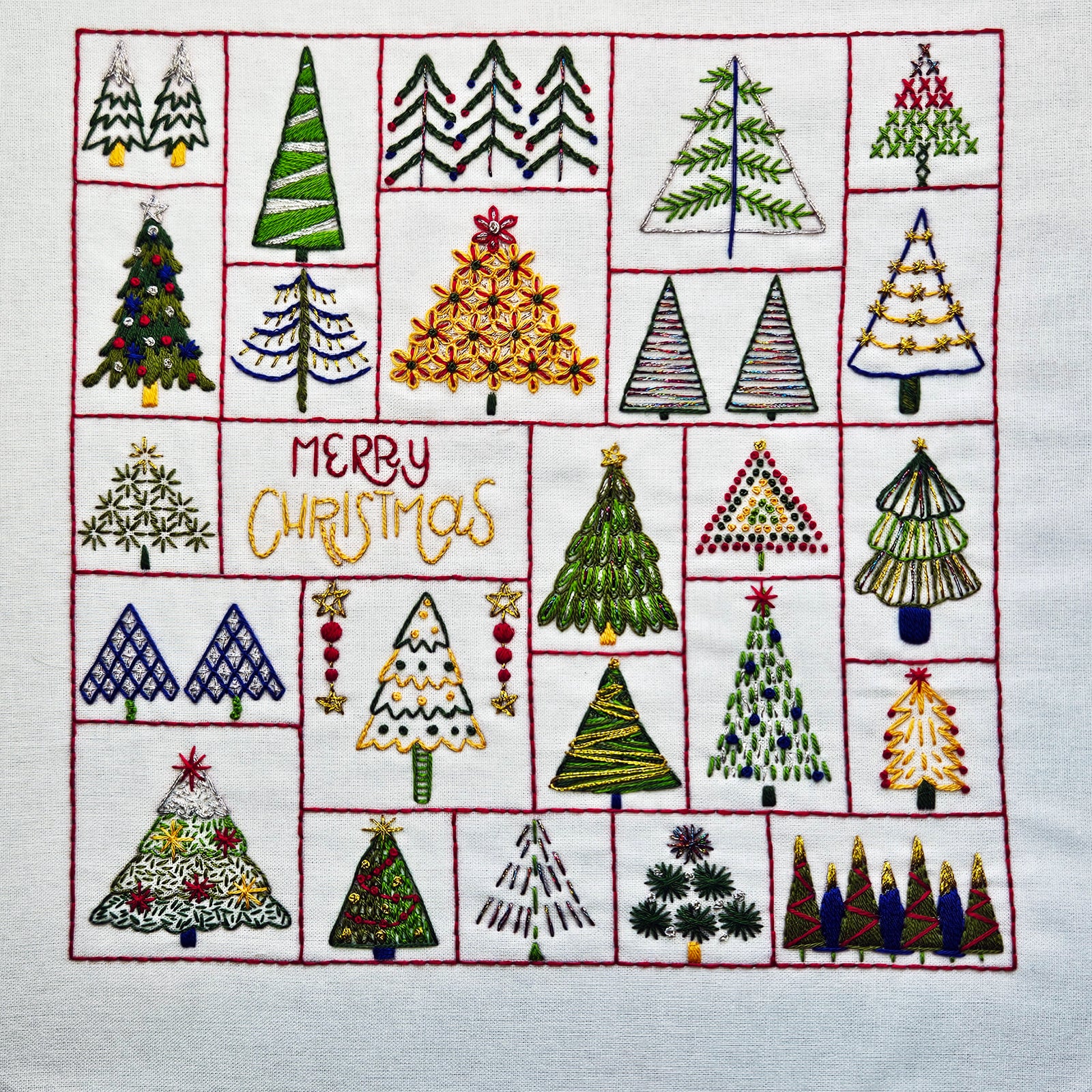 Embroidered patchwork of Christmas trees with 'Merry Christmas' text on a white background.