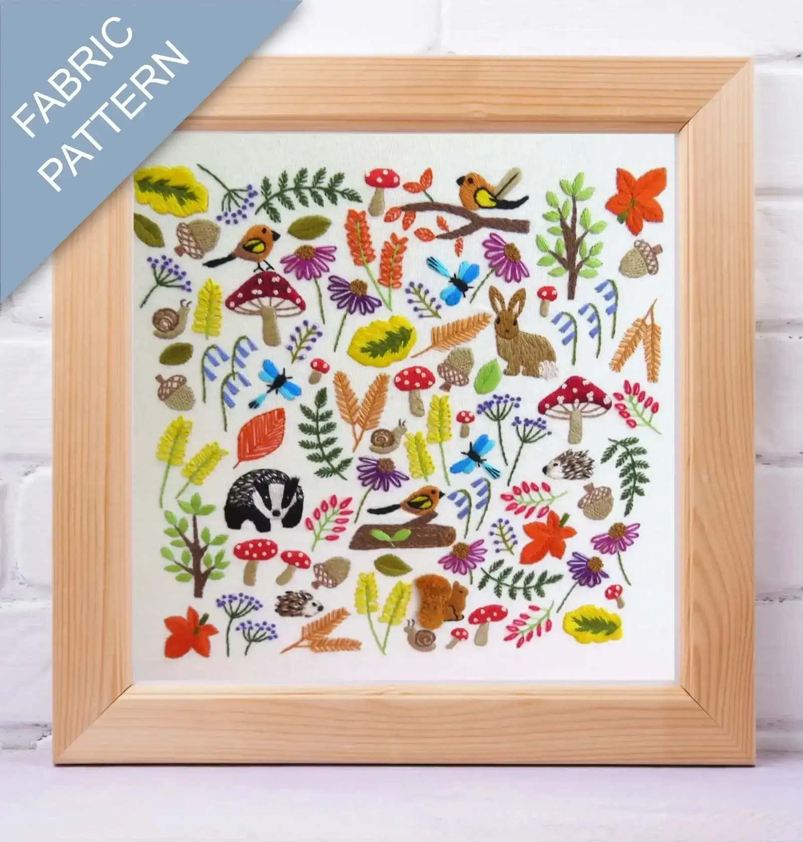 Framed fabric pattern with nature-themed designs on a white background