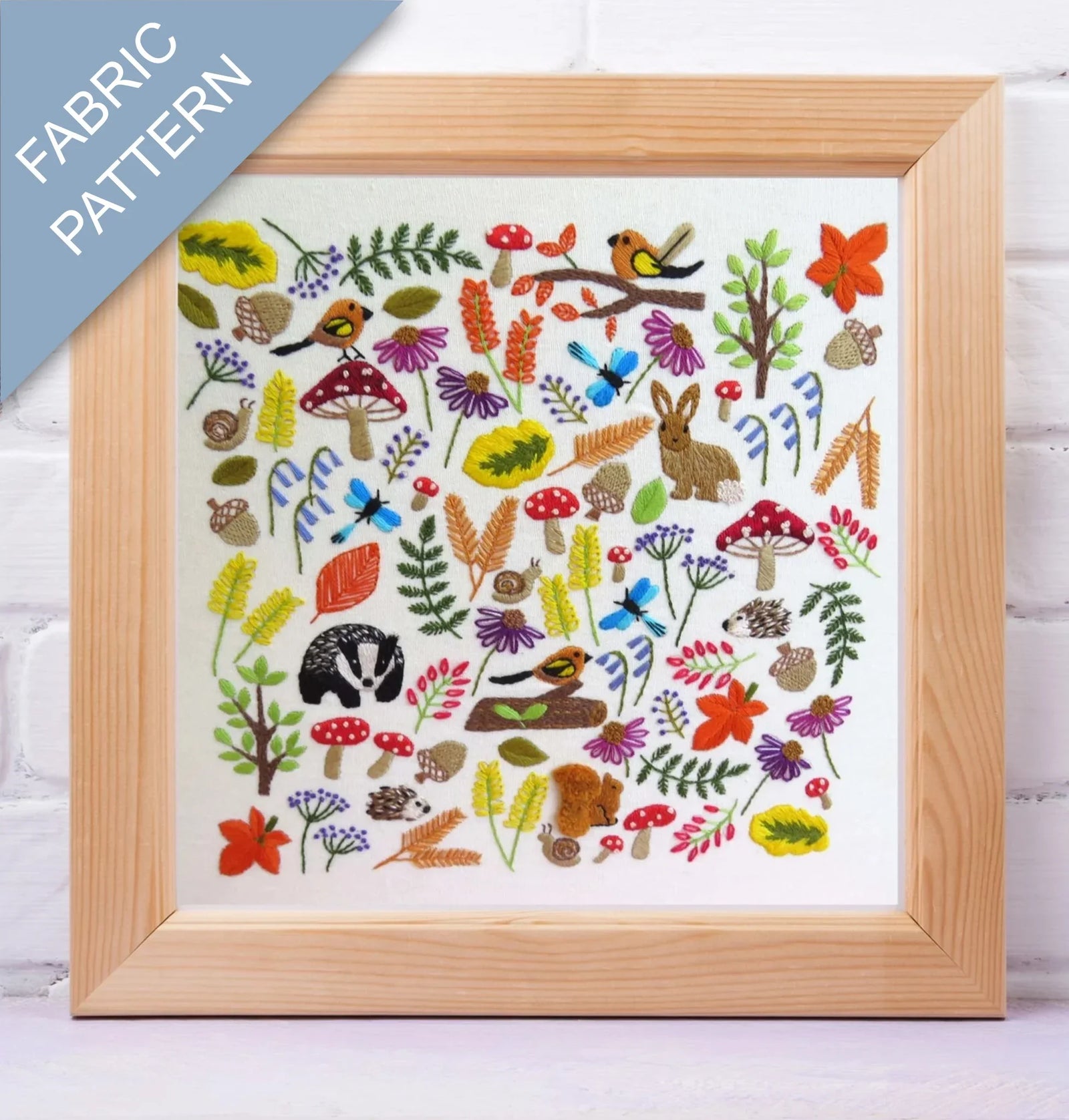 Framed fabric pattern with nature-themed designs on a white background