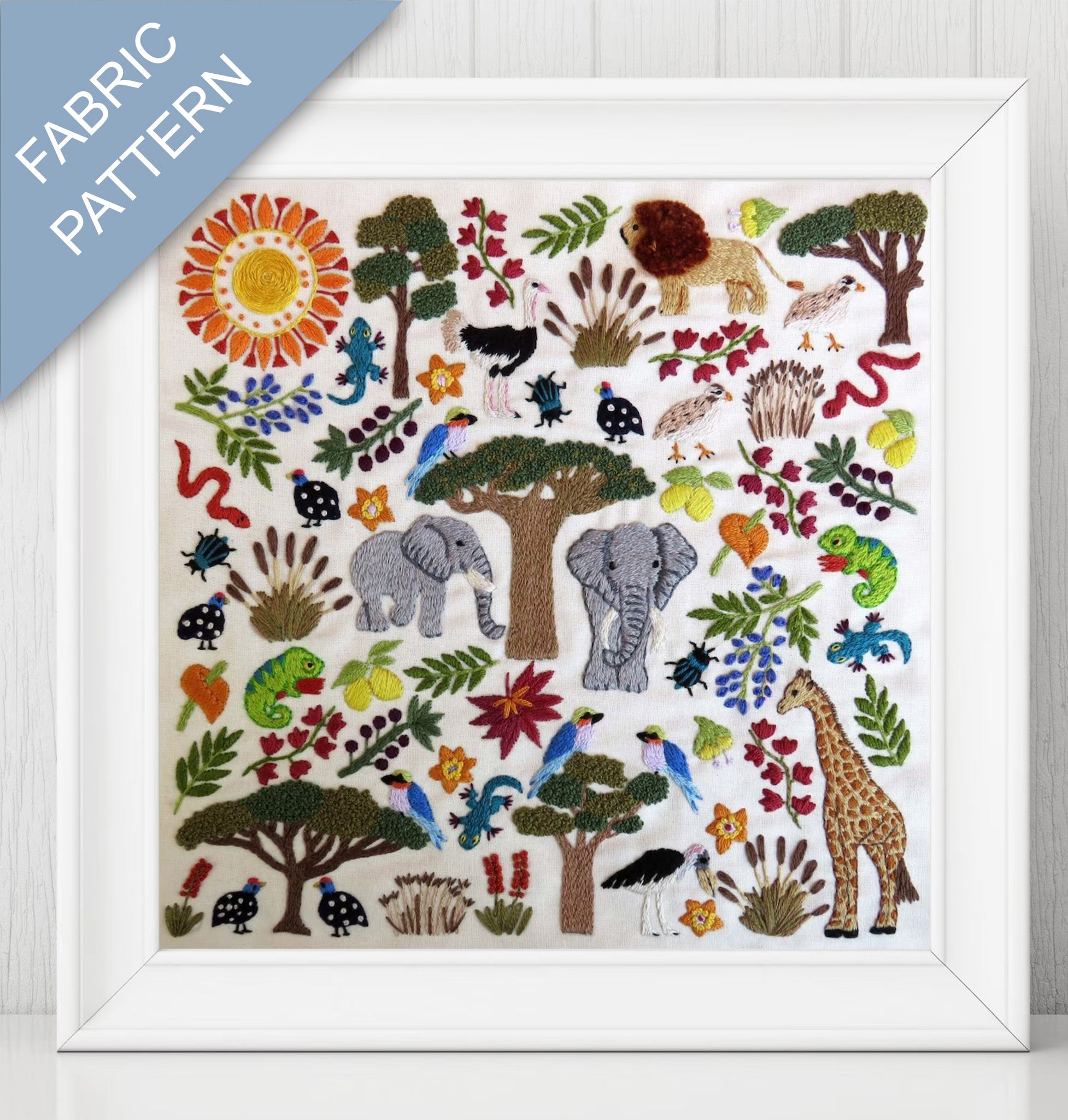 Framed fabric pattern with animals, trees, and plants on a white background