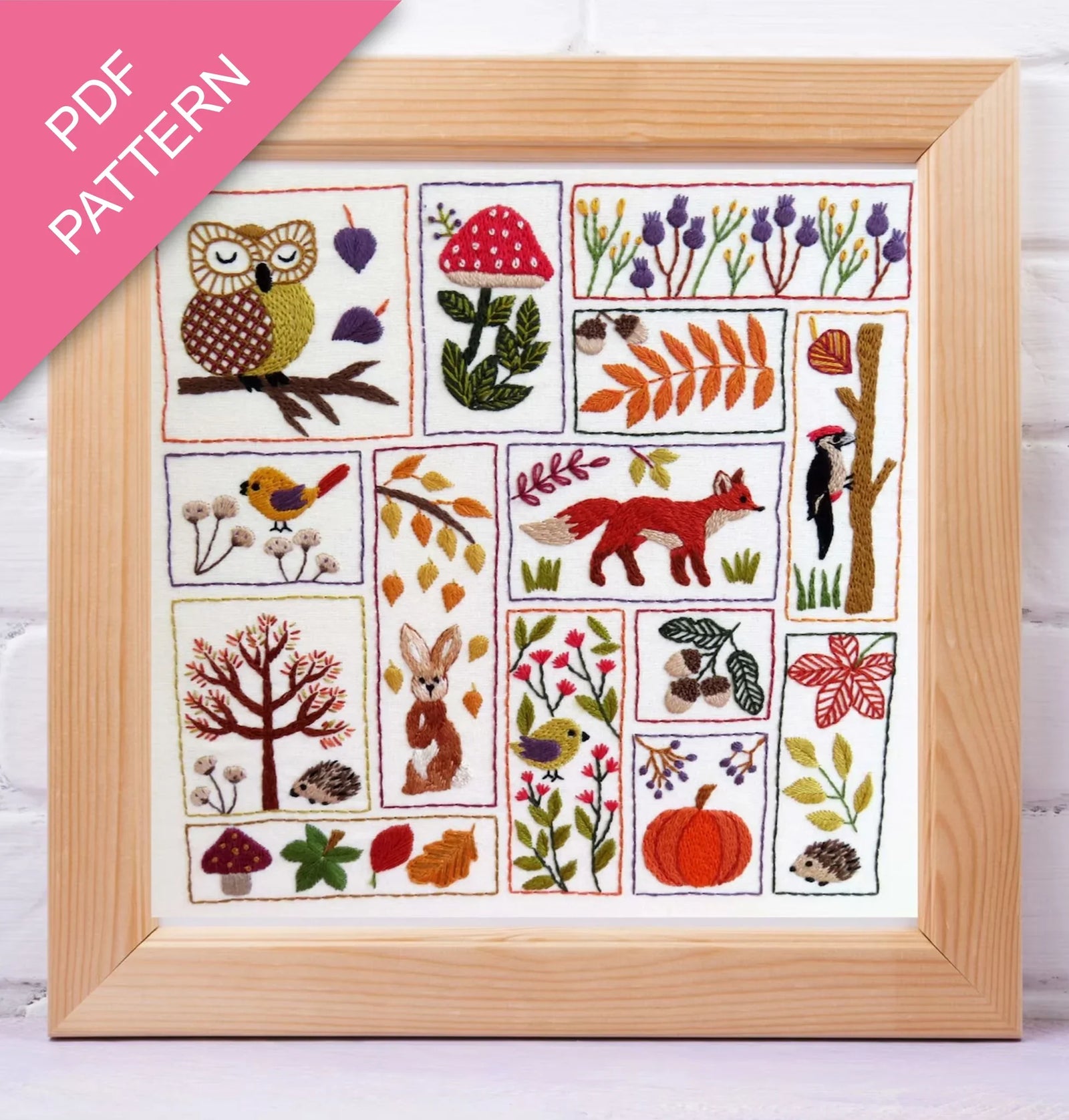 Framed embroidery pattern with nature-themed designs on a white background