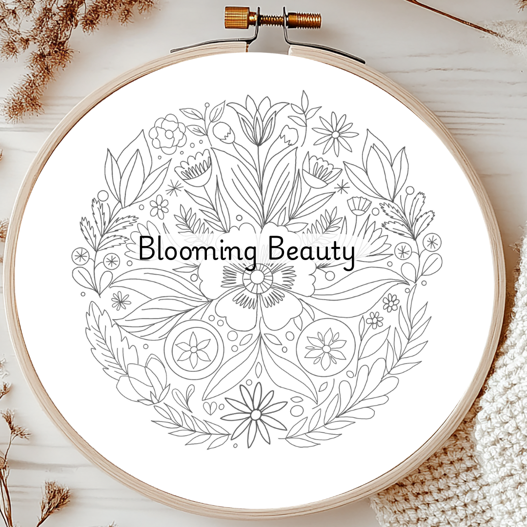 Embroidery hoop with floral design and 'Blooming Beauty' text on a white background