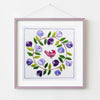 Embroidered artwork with a bird and floral design in a purple frame on a white background