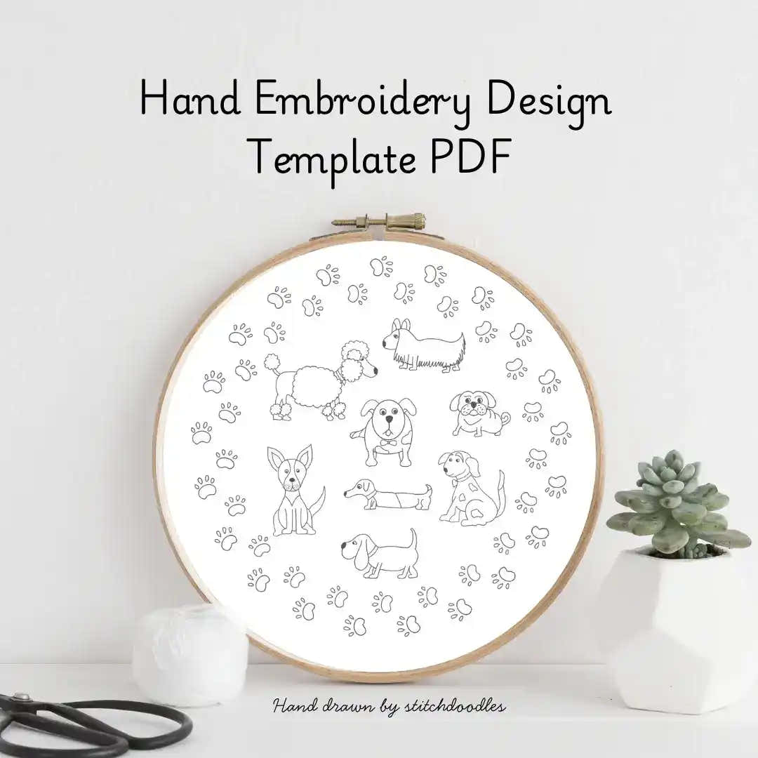 Hand embroidery design template with dogs and paw prints in an embroidery hoop on a white background.