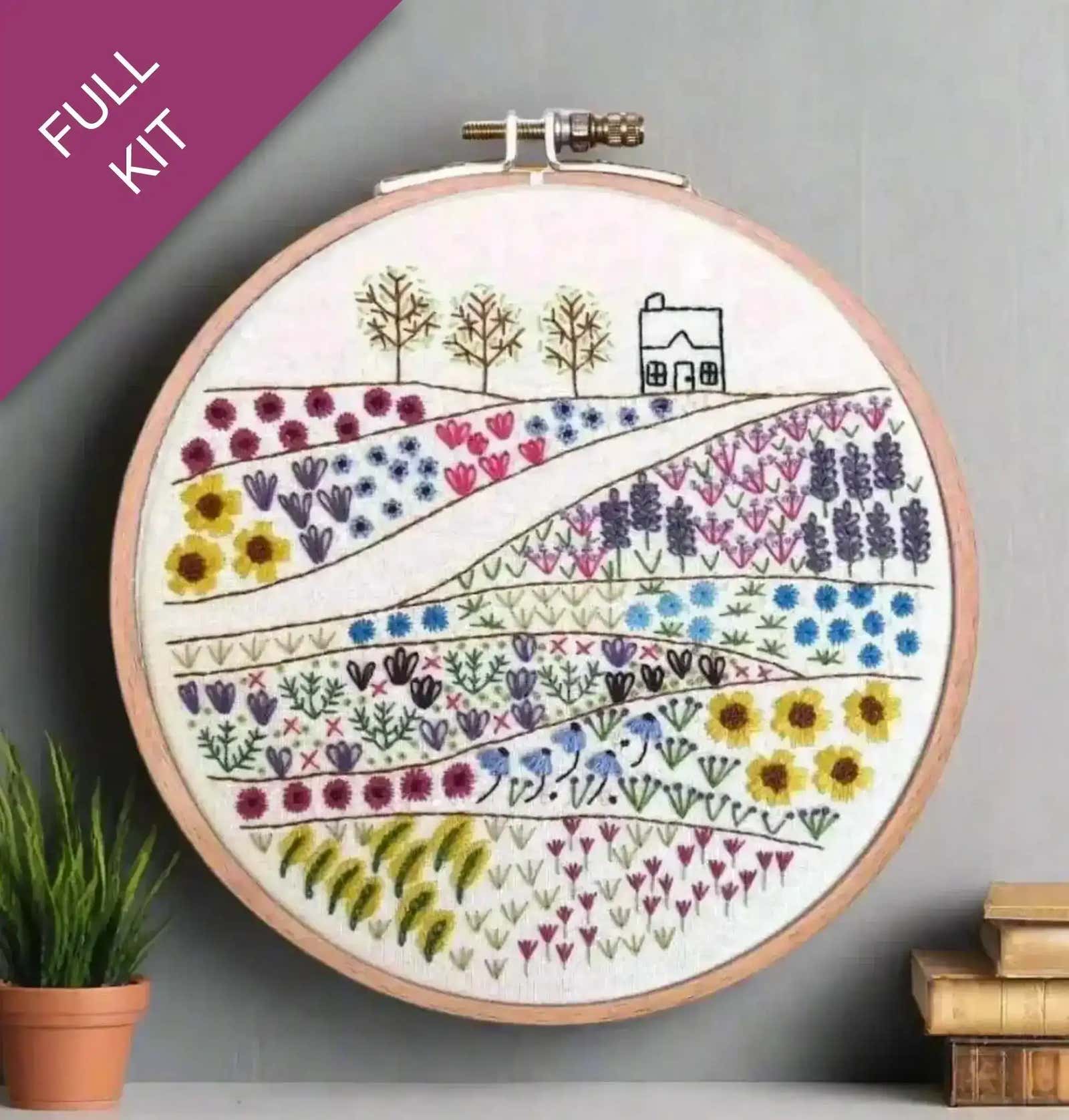 Embroidery hoop with floral design on a gray background