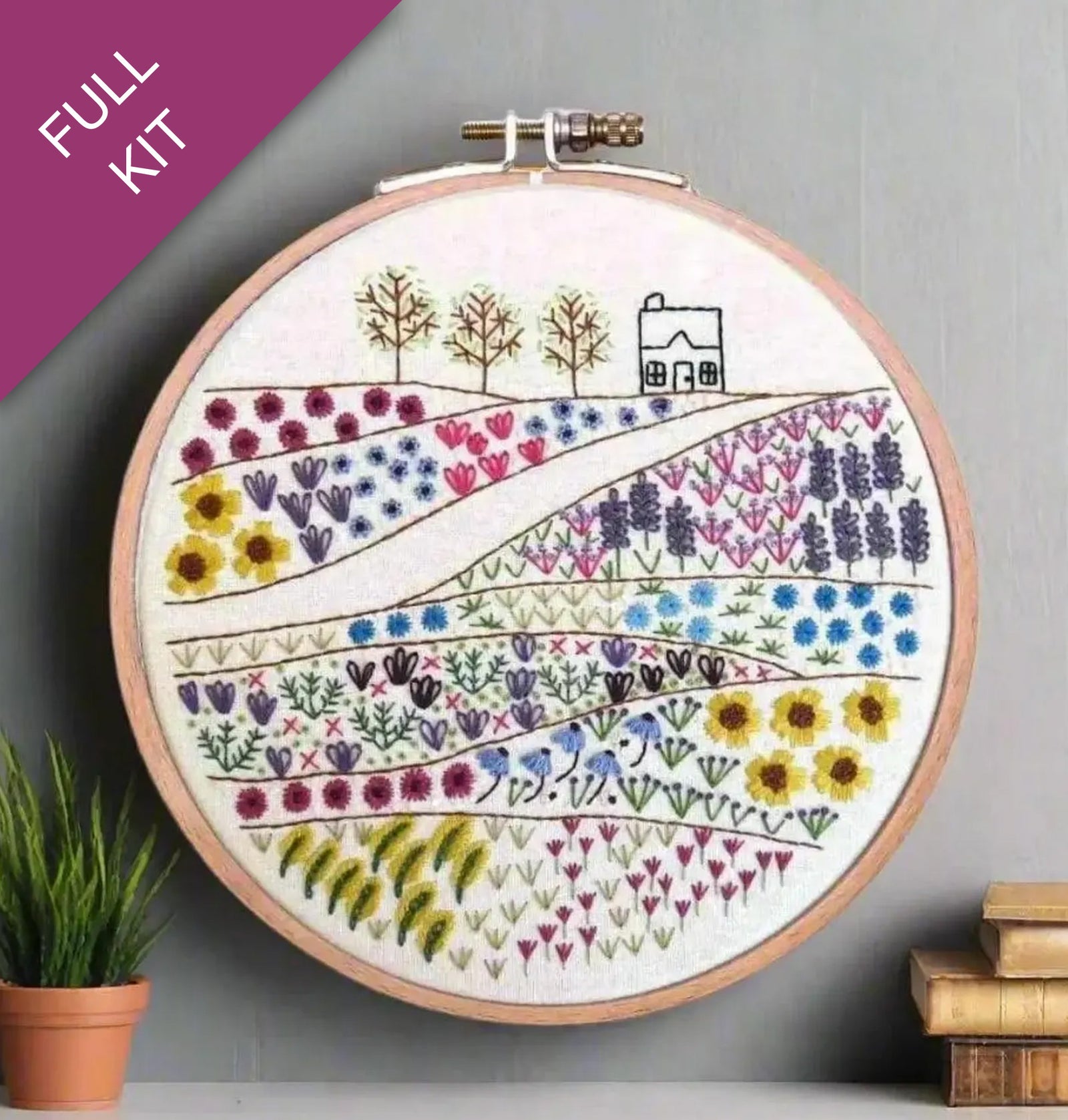 Embroidery hoop with floral design on a gray background