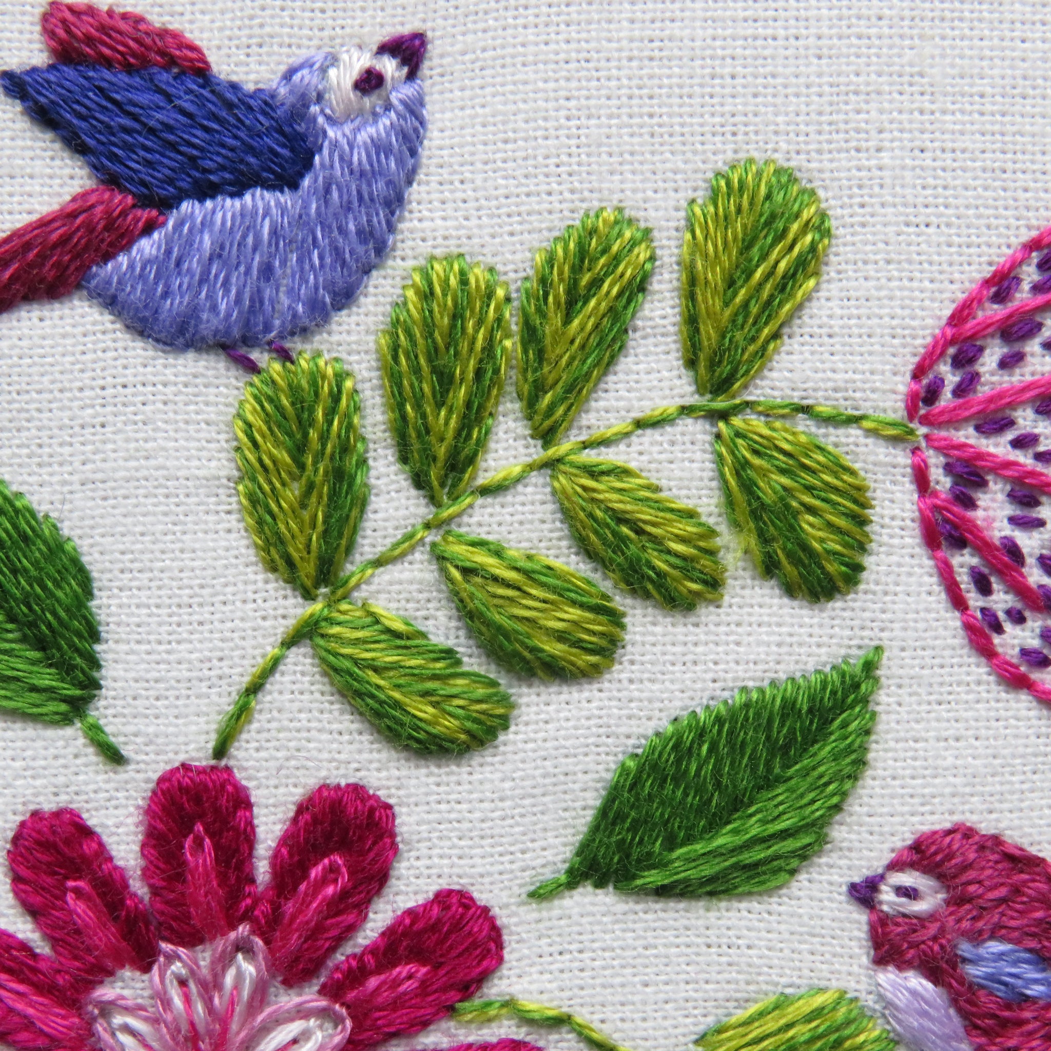 Embroidery design with birds and flowers on a white background