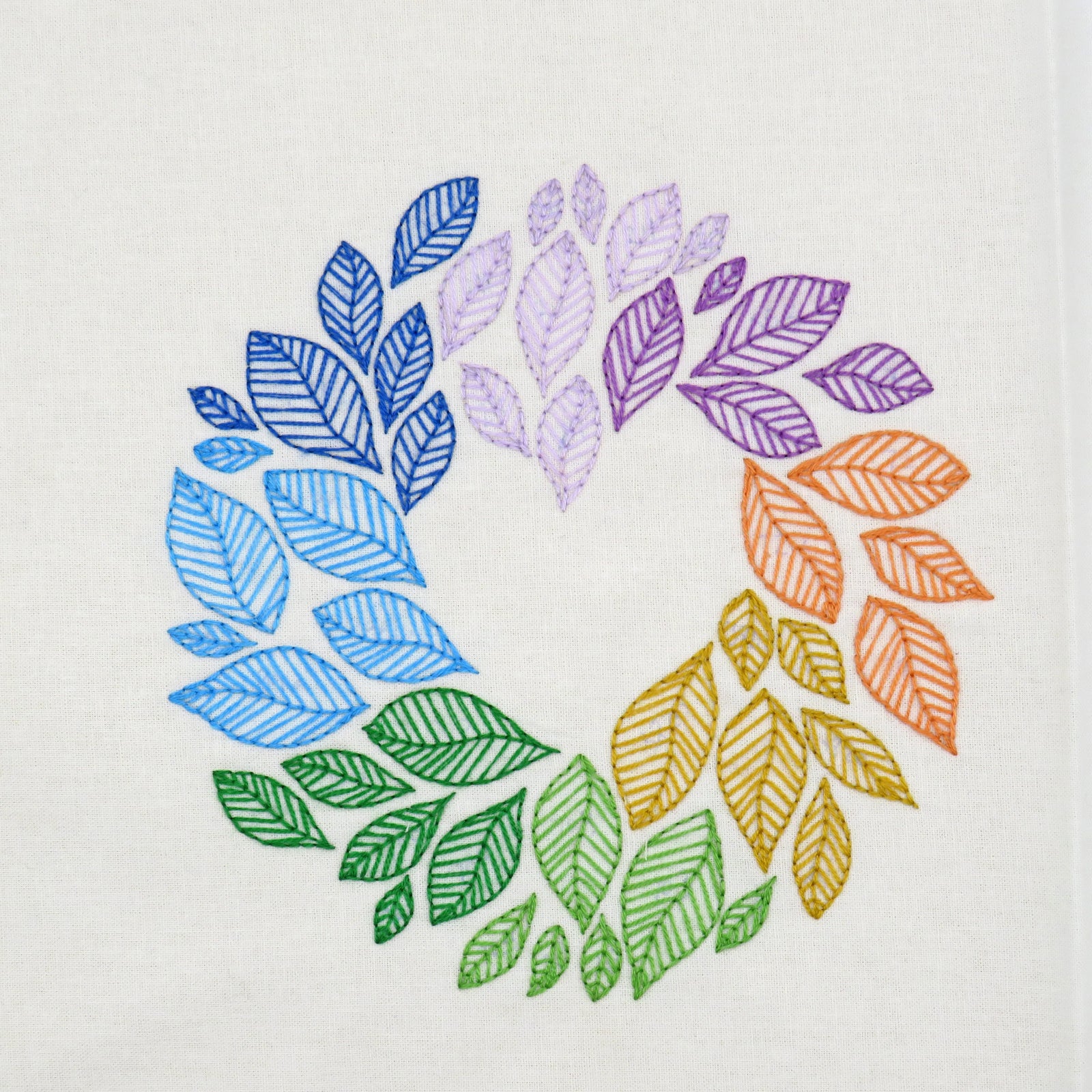 Colorful leaf pattern in a circular arrangement on a white background