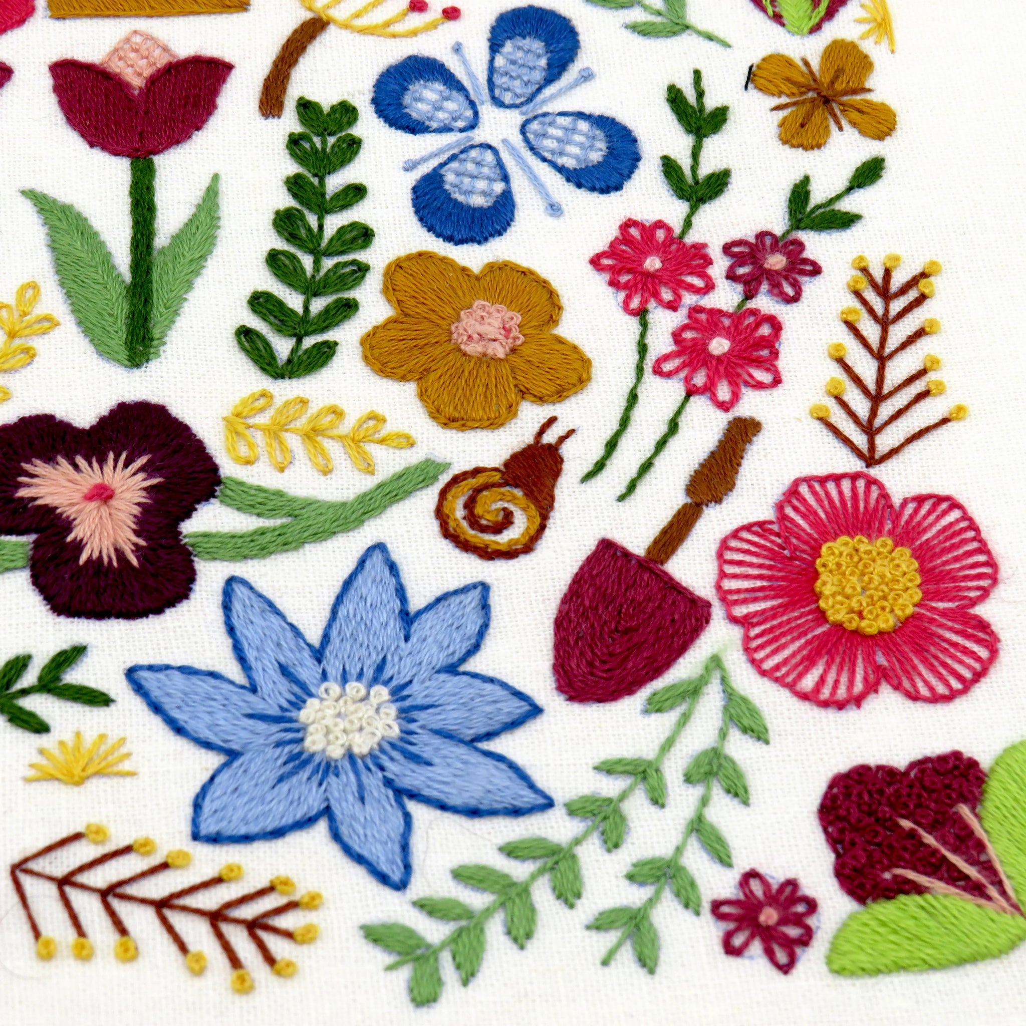 Garden lovers will delight in all the wonderful flora and fauna to be stitched in this beautiful hand embroidery sampler.

There are an abundance of flowers to explore including Tulips, Pansies and Daisies which are intermingled with foliage, pots and snails! A Hand Embroidery Sampler to keep you smiling the whole way through.