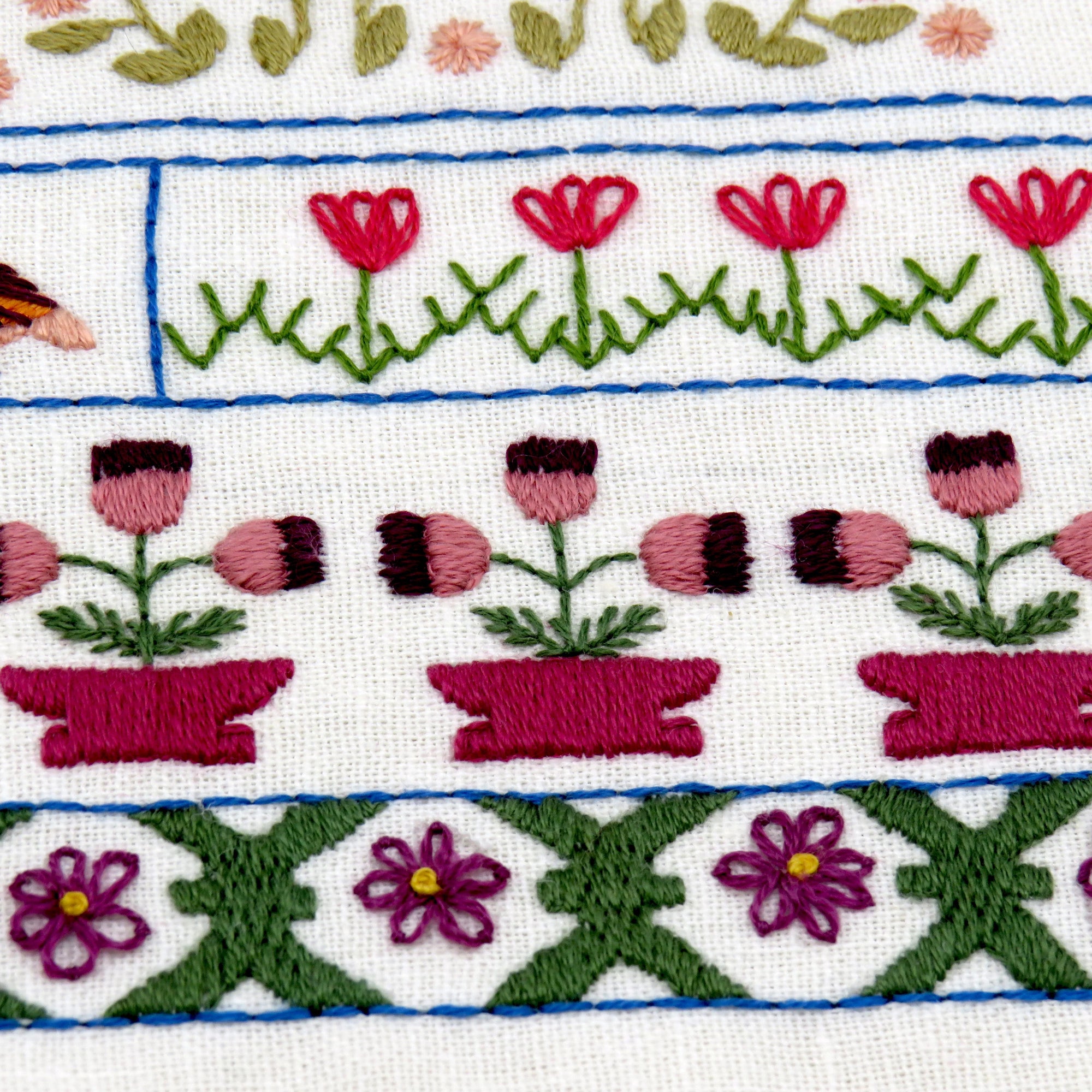 Embroidered pattern with flowers and plants on a white background