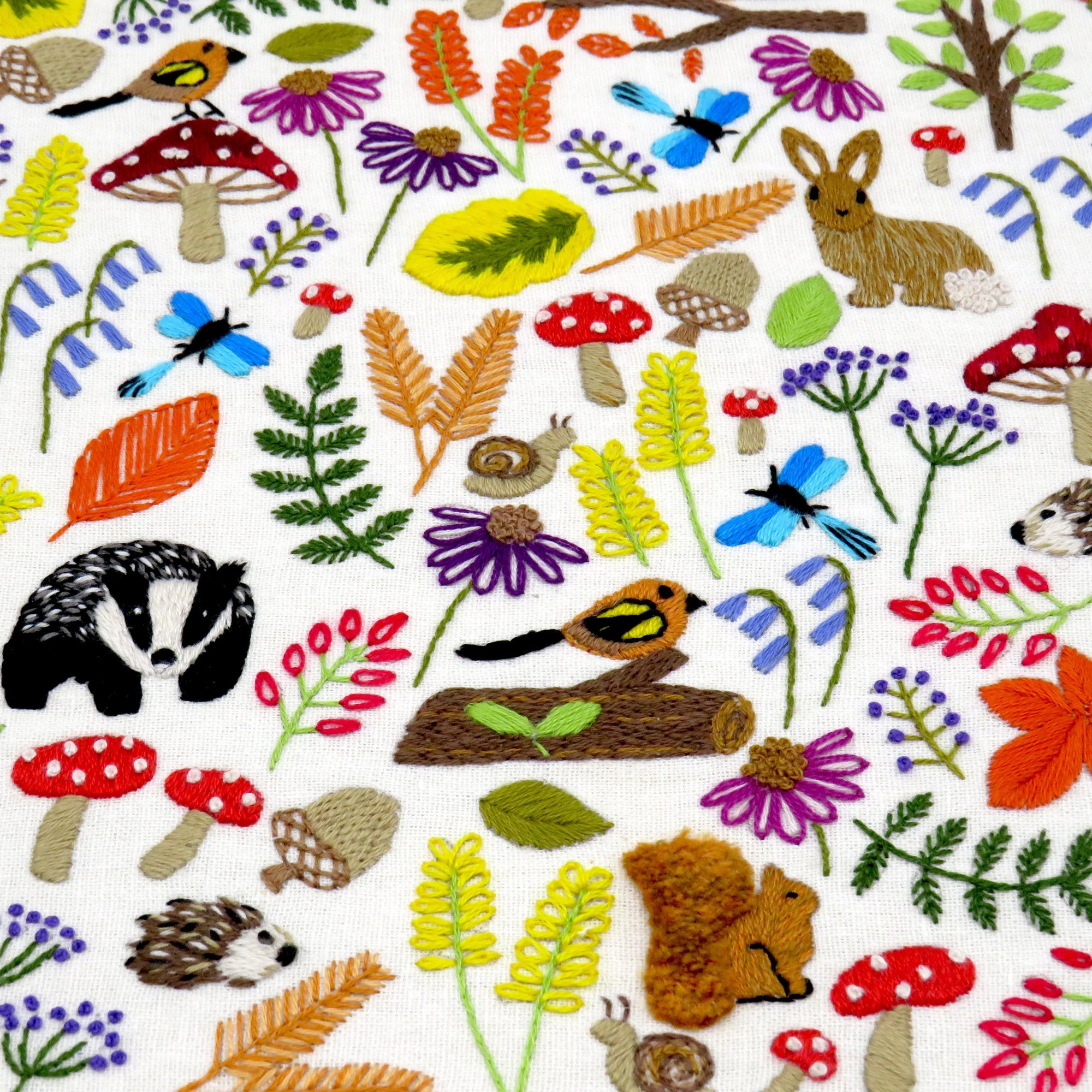 Pattern of forest animals and plants on a white background