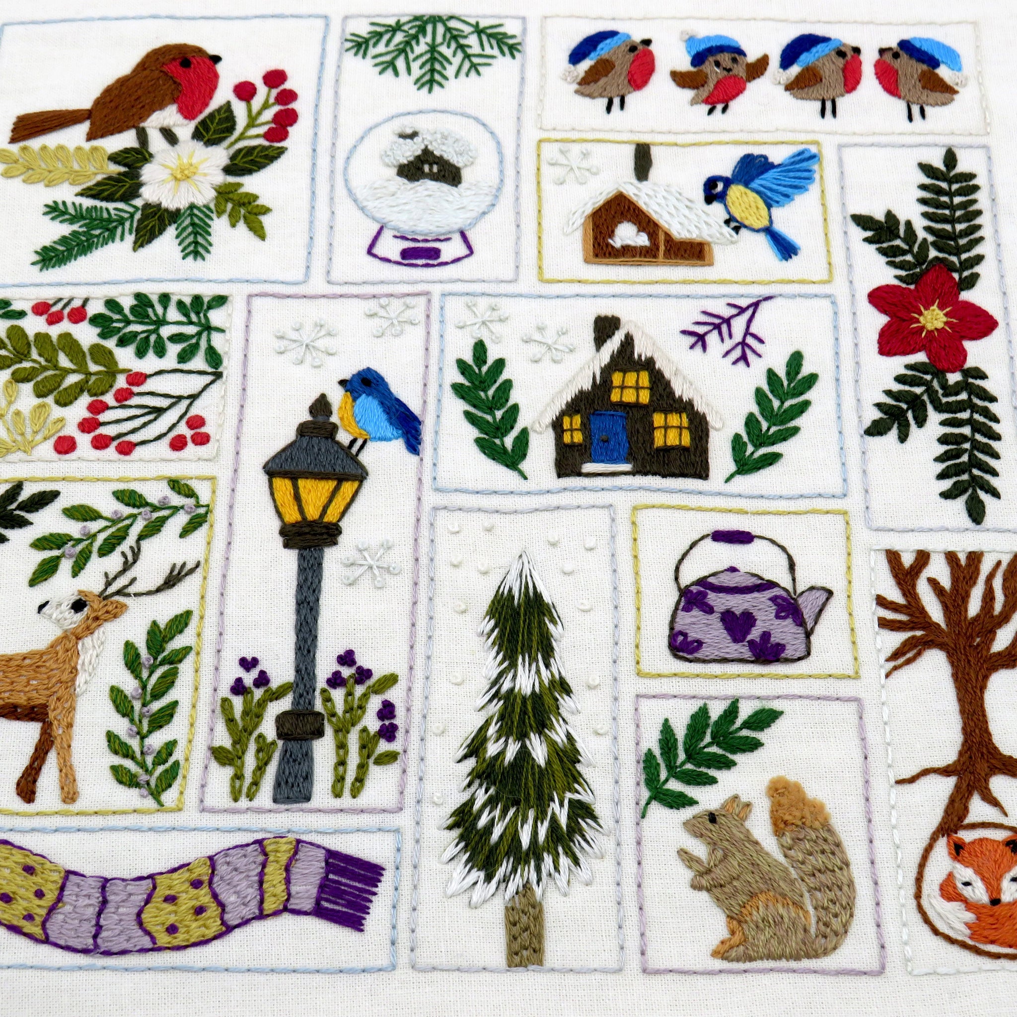 Embroidered patch collection with nature-themed designs including birds, flowers, and animals.
