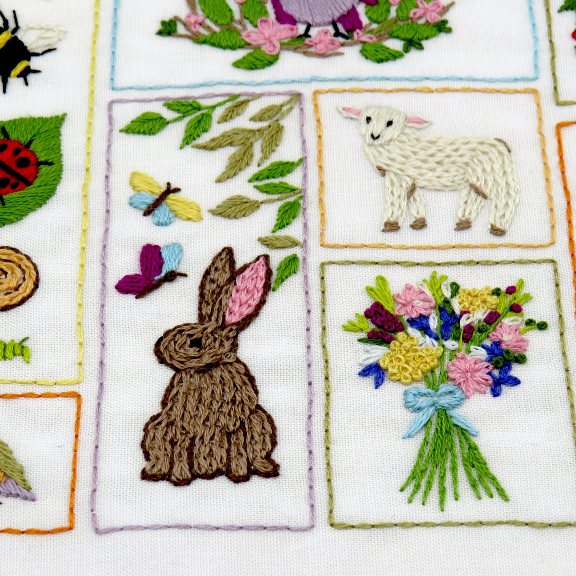 Embroidered patches with various designs including a rabbit, flowers, and nature elements.