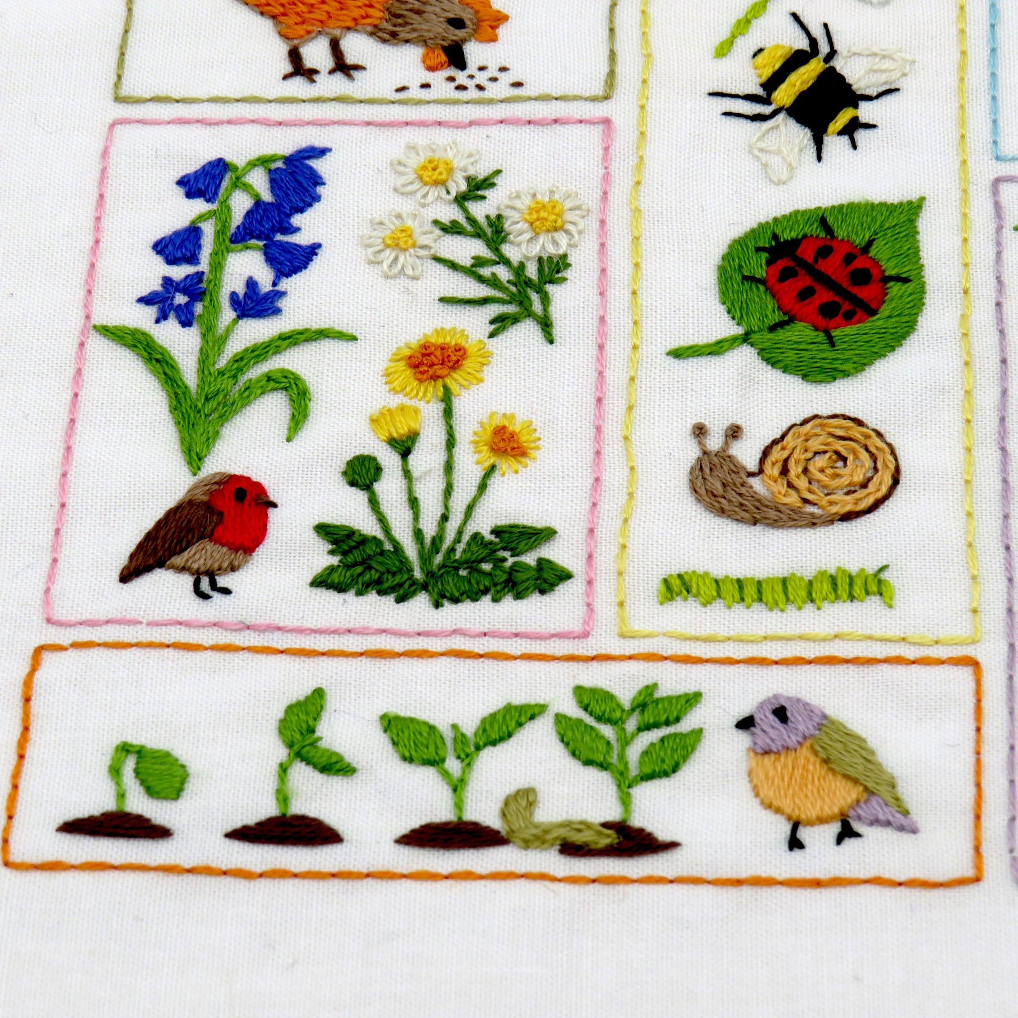 Embroidered patches with various nature-themed designs including flowers, birds, and insects.
