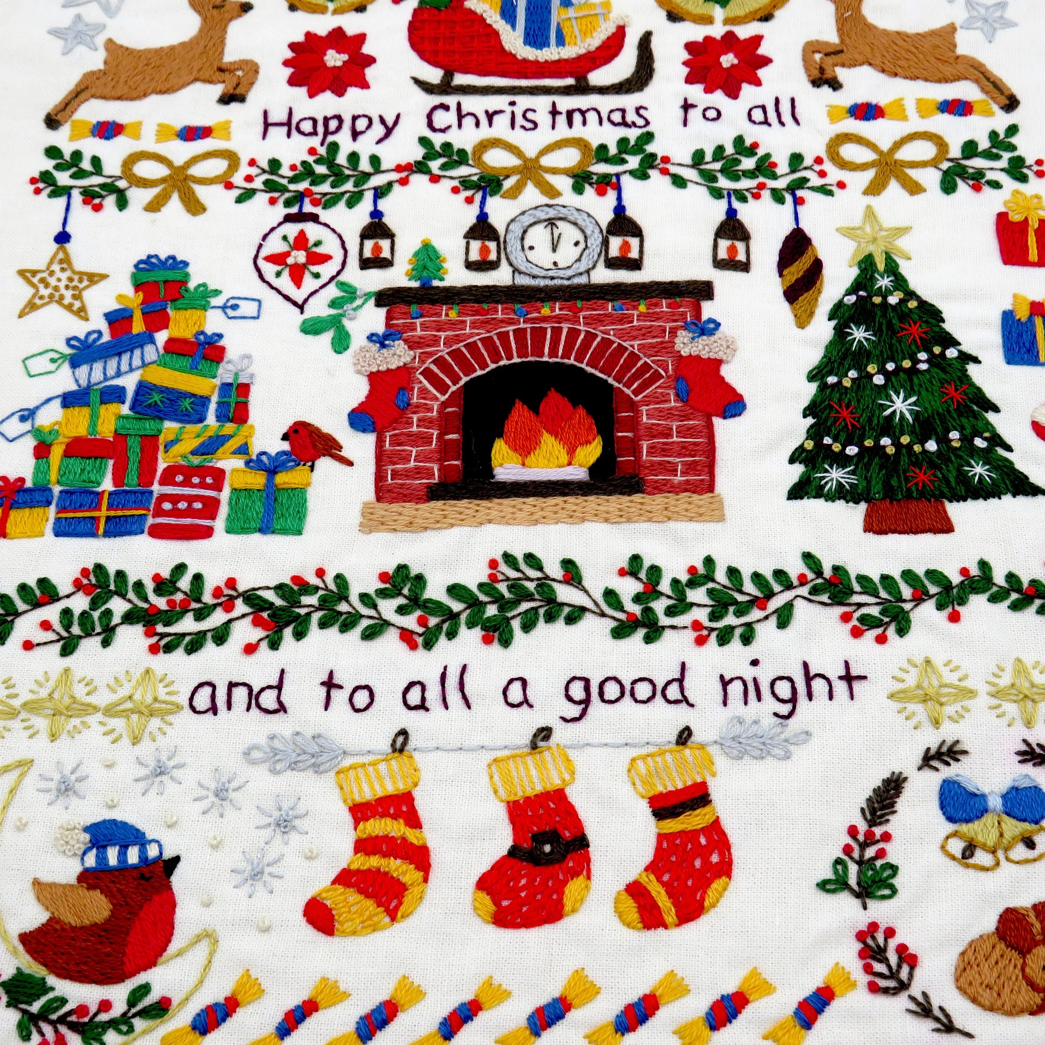 Decorative Christmas pattern with fireplace, tree, presents, and stockings on a white background.