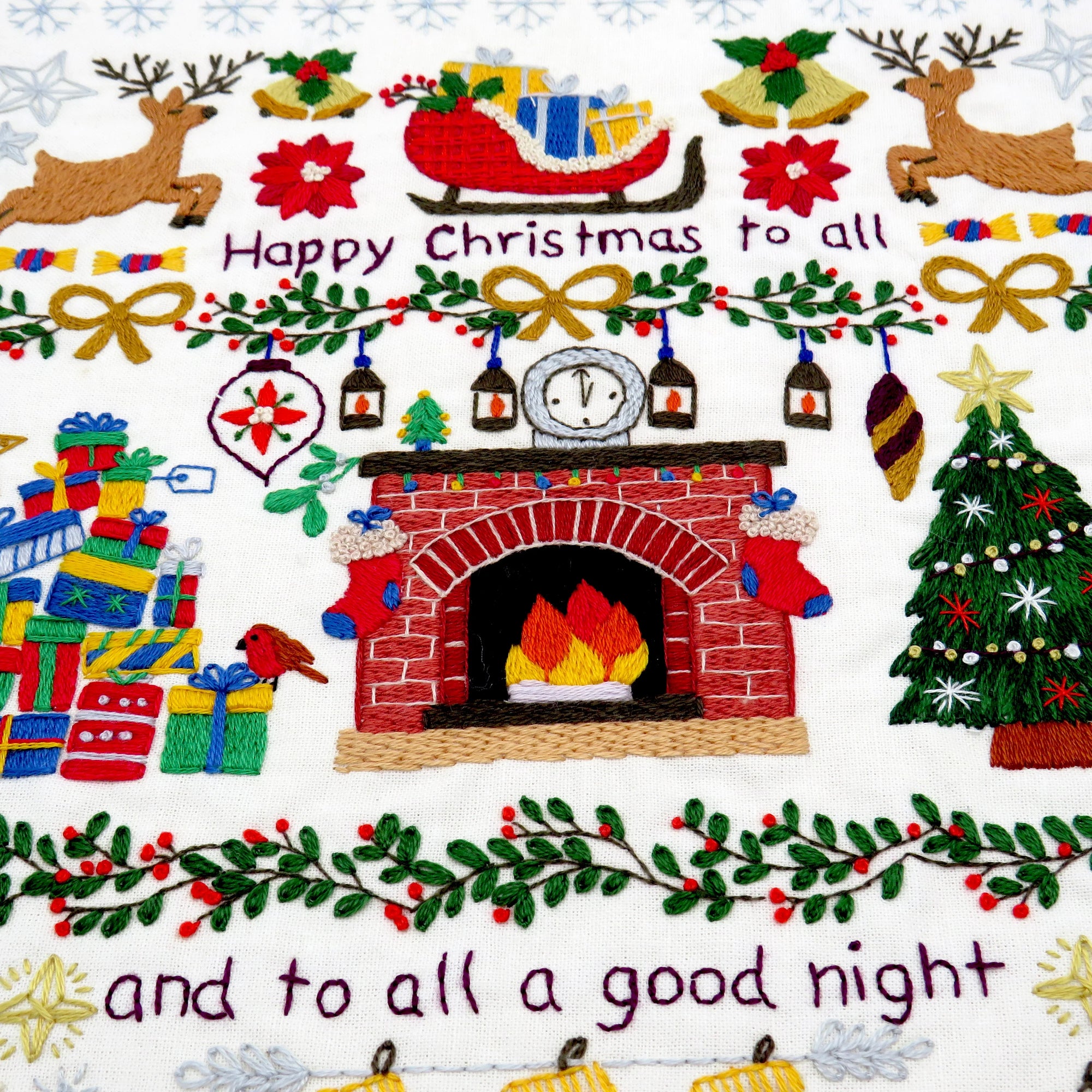 Decorative Christmas scene with fireplace, reindeer, presents, and text on a white background.