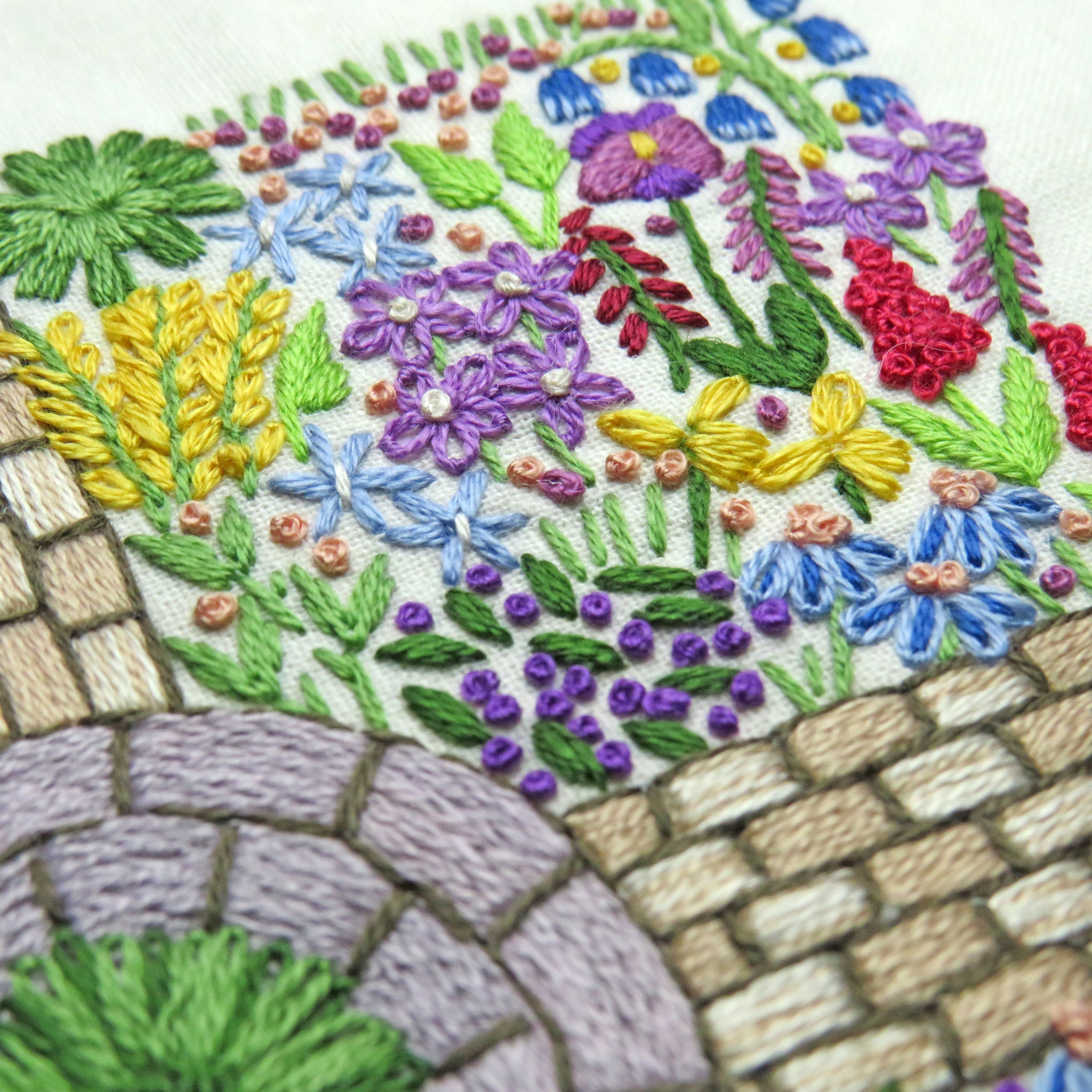 Embroidered design of flowers and stone pavement
