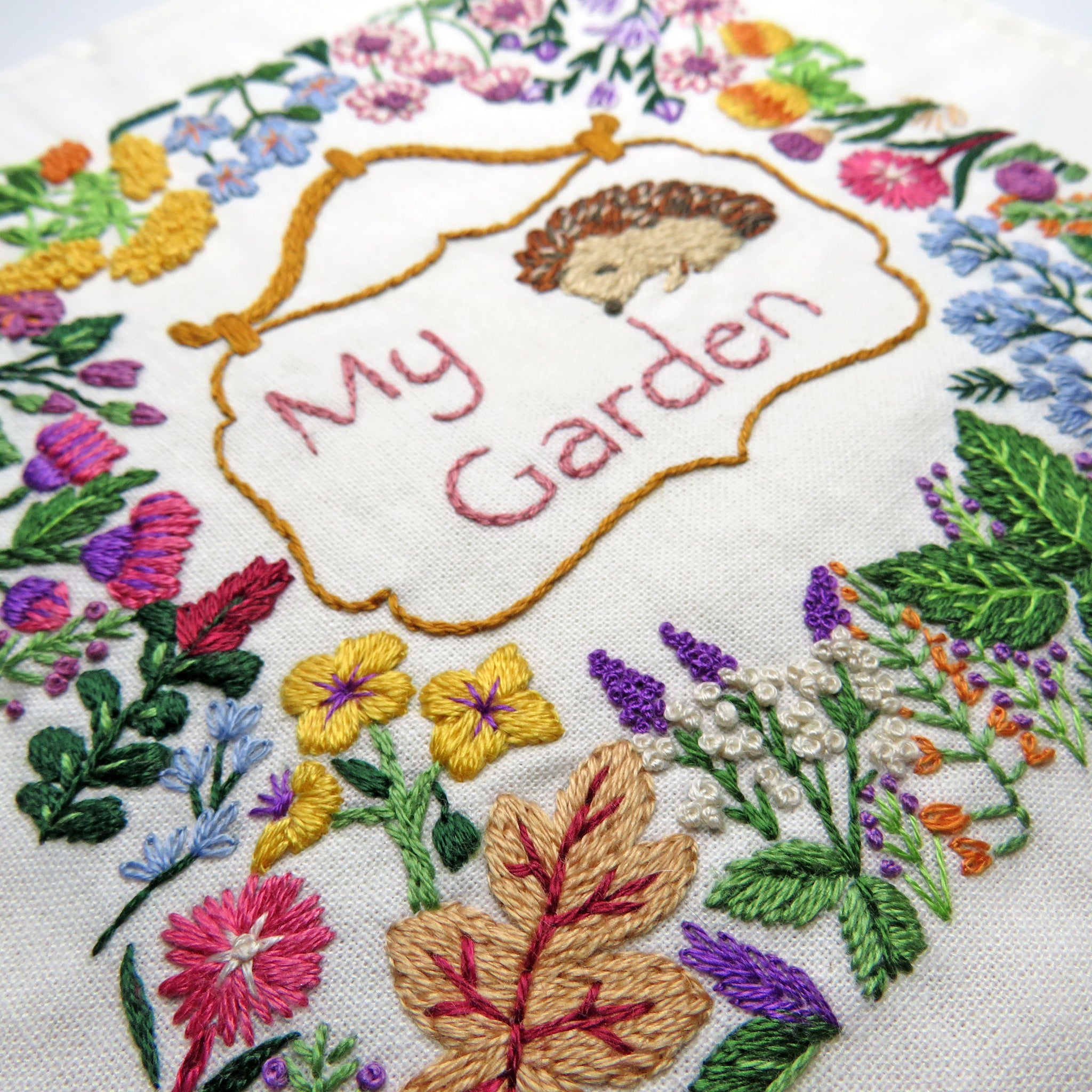 Embroidery with floral patterns and 'My Garden' text