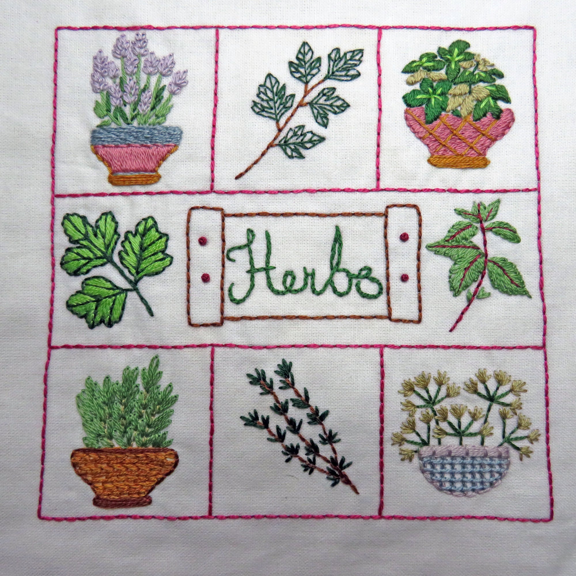 Embroidered design of various herbs in pots and branches on a white background.