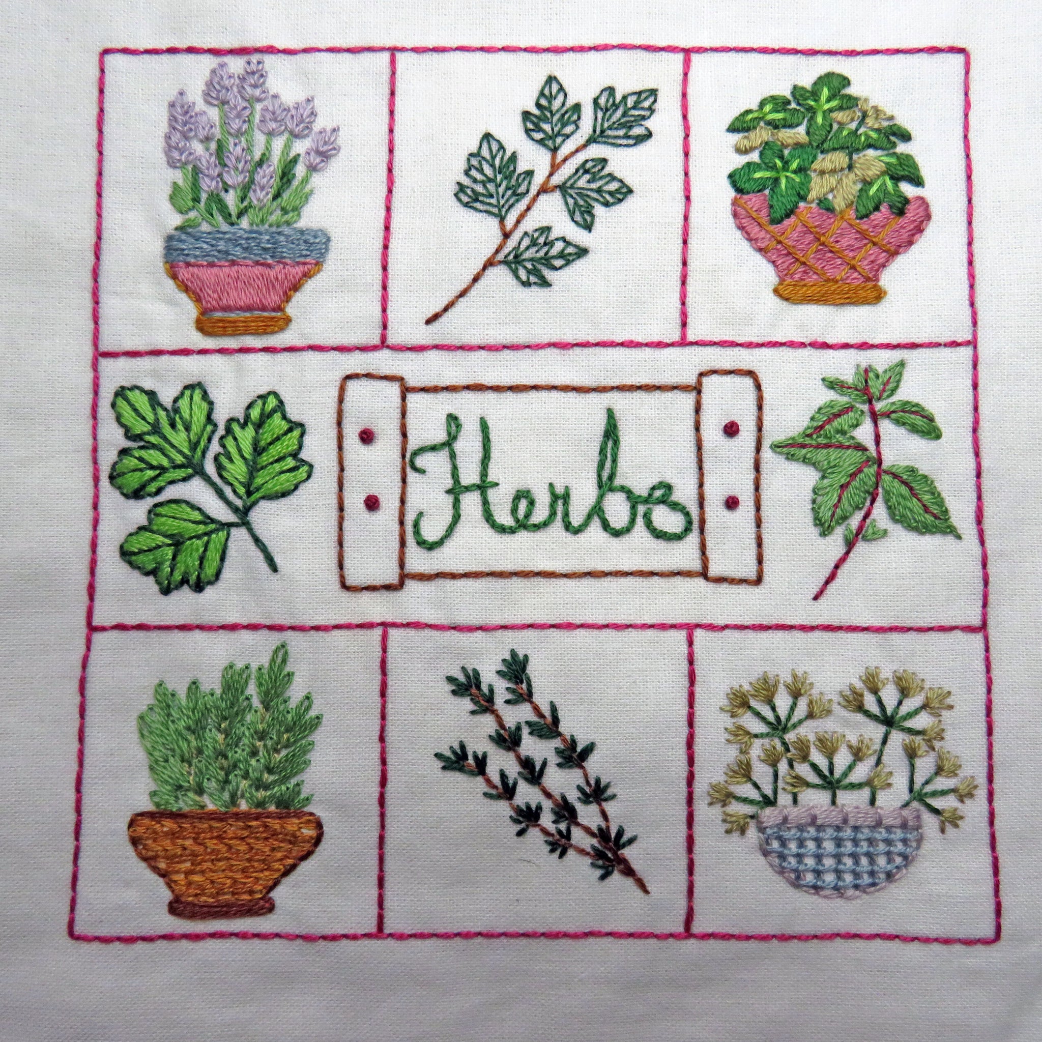 Embroidered design of various herbs in pots and branches on a white background.