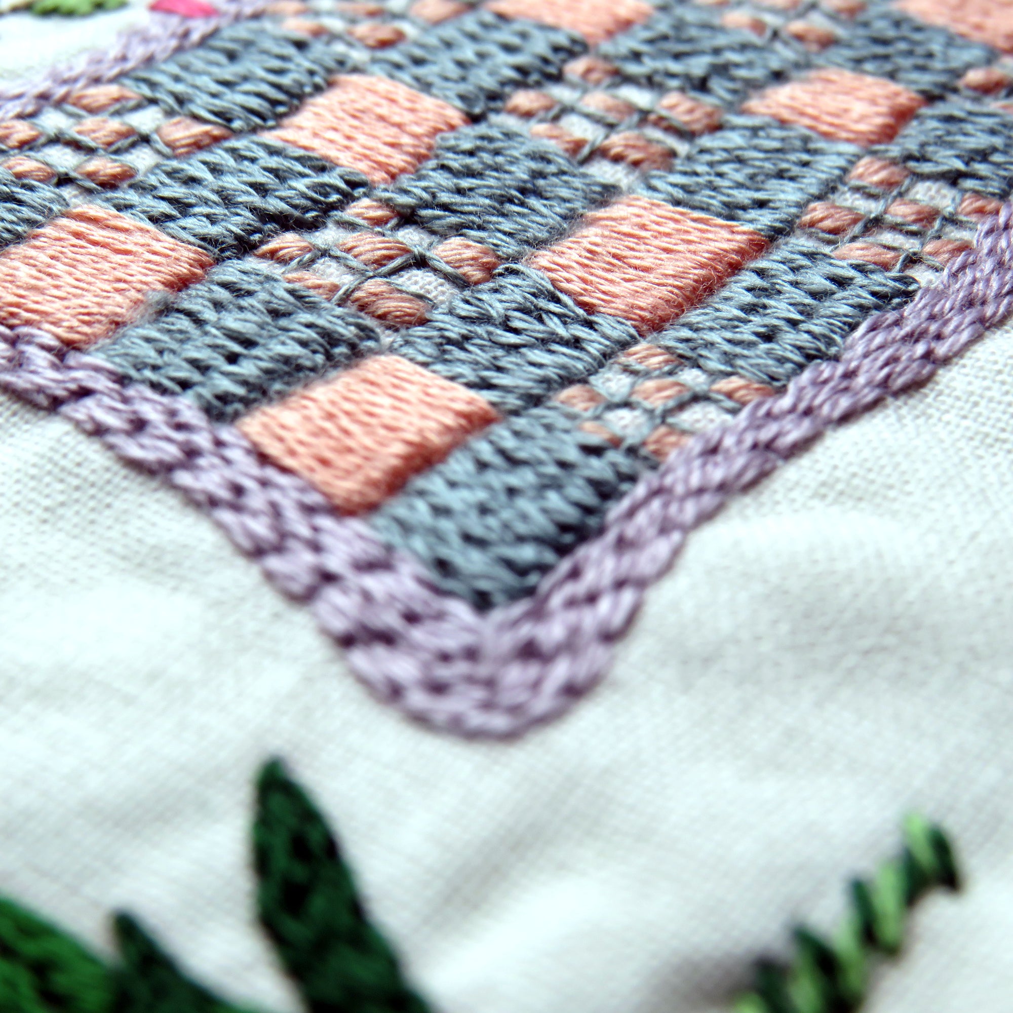 Close-up of a cross-stitched fabric with geometric pattern
