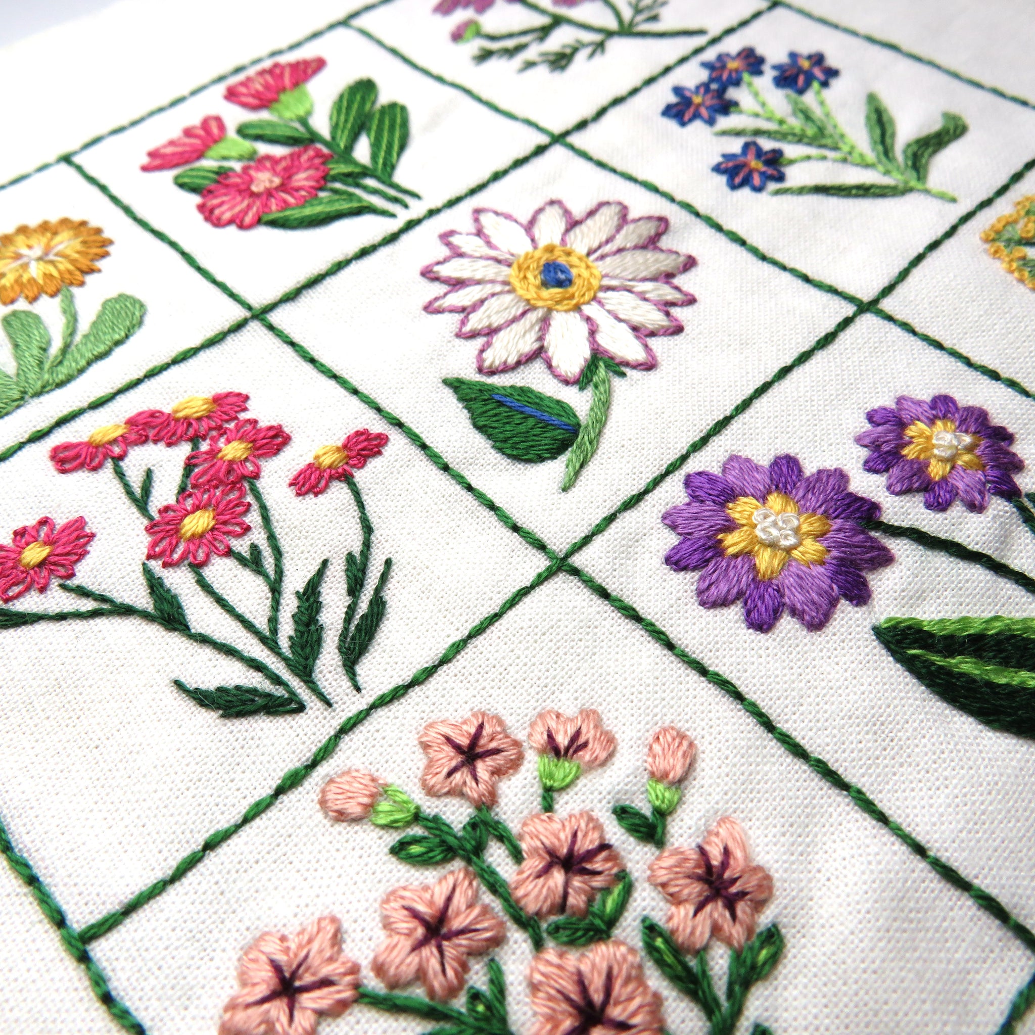 Embroidered floral patterns on a white fabric background