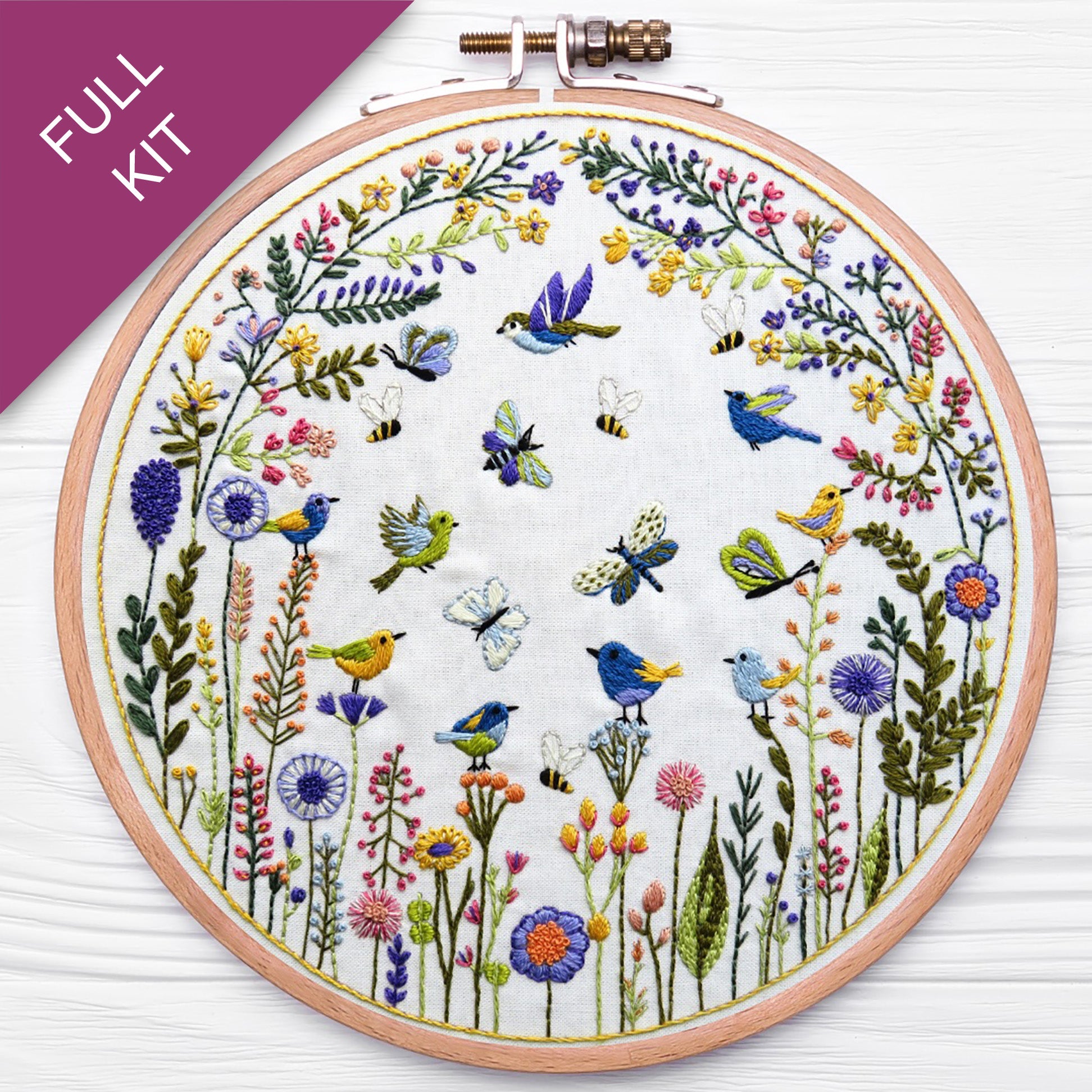 Embroidery hoop with floral and bird design on a white background