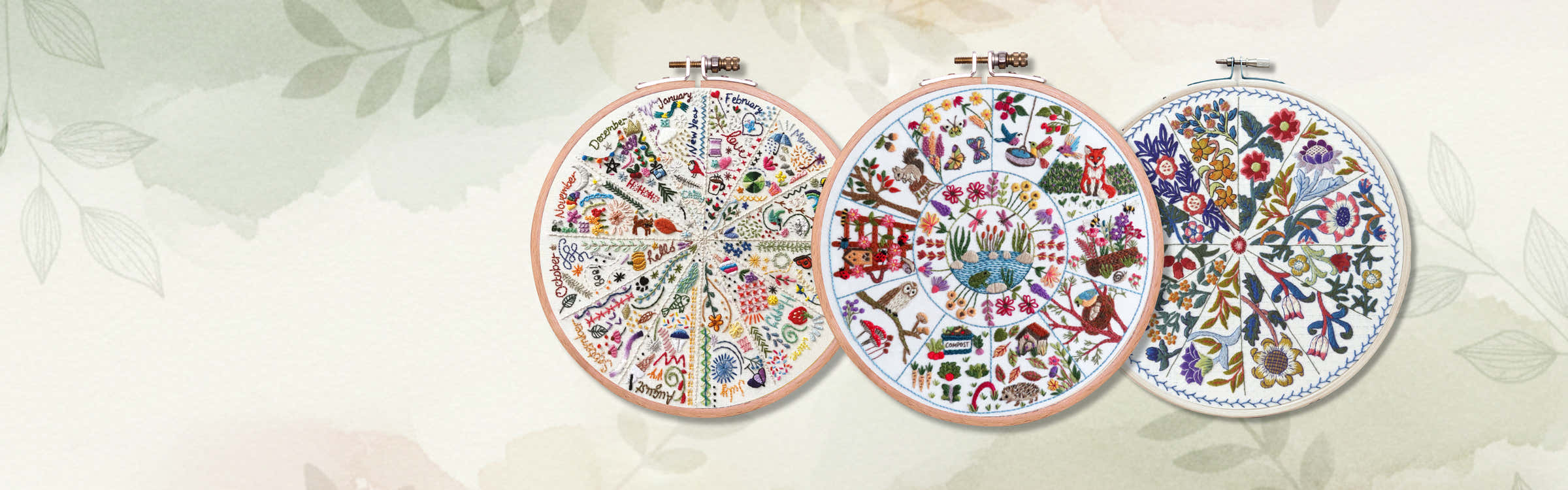 Stitchdoodles modern hand embroidery. Three embroidery hoops with colorful floral patterns on a light background