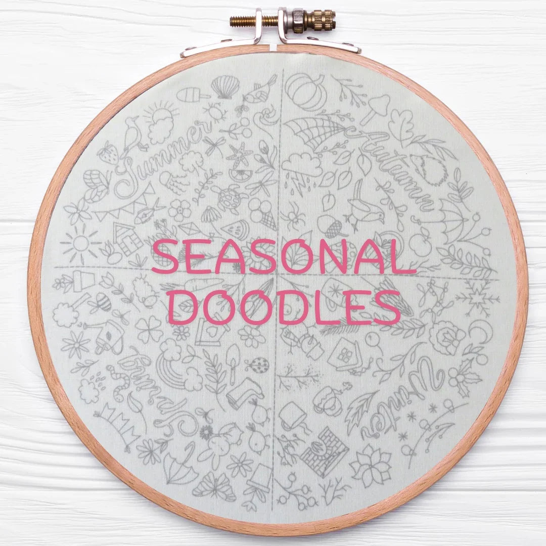 Embroidery hoop with 'SEASONAL DOODLES' text on a light gray background