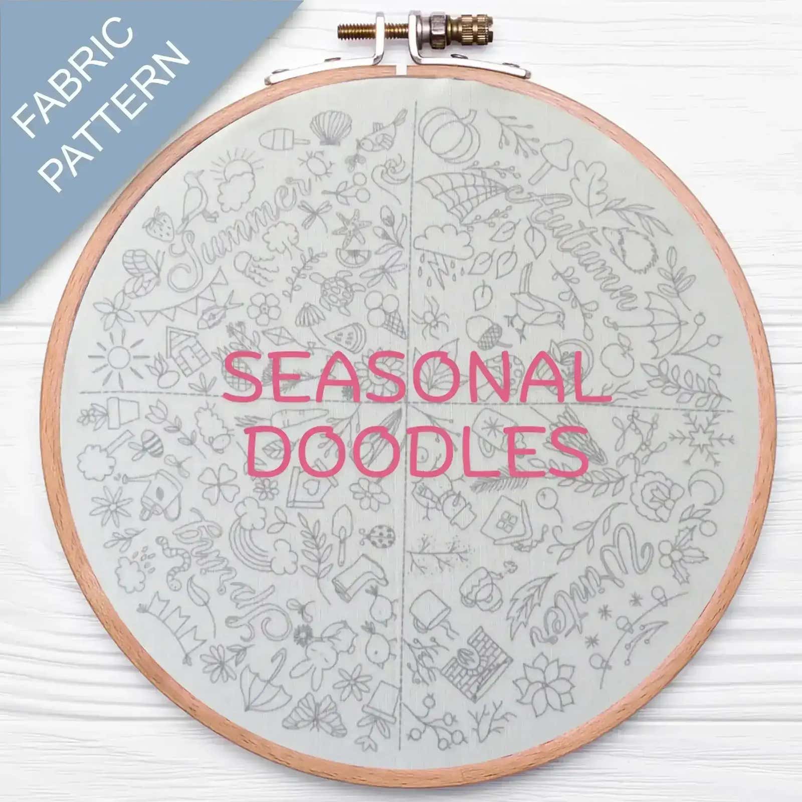 Embroidery hoop with 'Seasonal Doodles' fabric pattern on a white background
