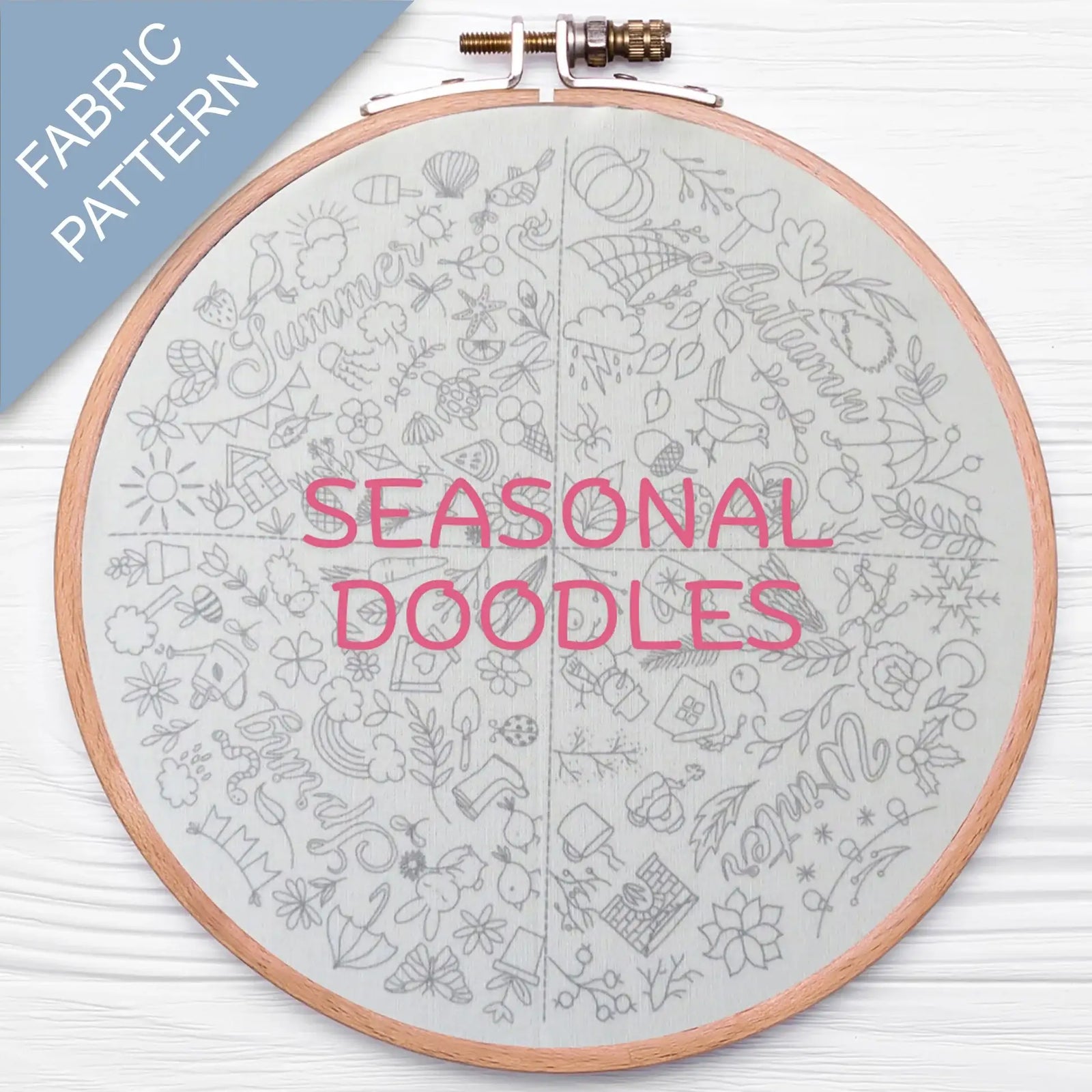 Embroidery hoop with 'Seasonal Doodles' fabric pattern on a white background
