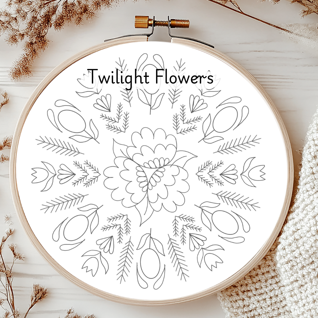 Embroidery hoop with floral pattern and 'Twilight Flowers' text on a wooden surface.
