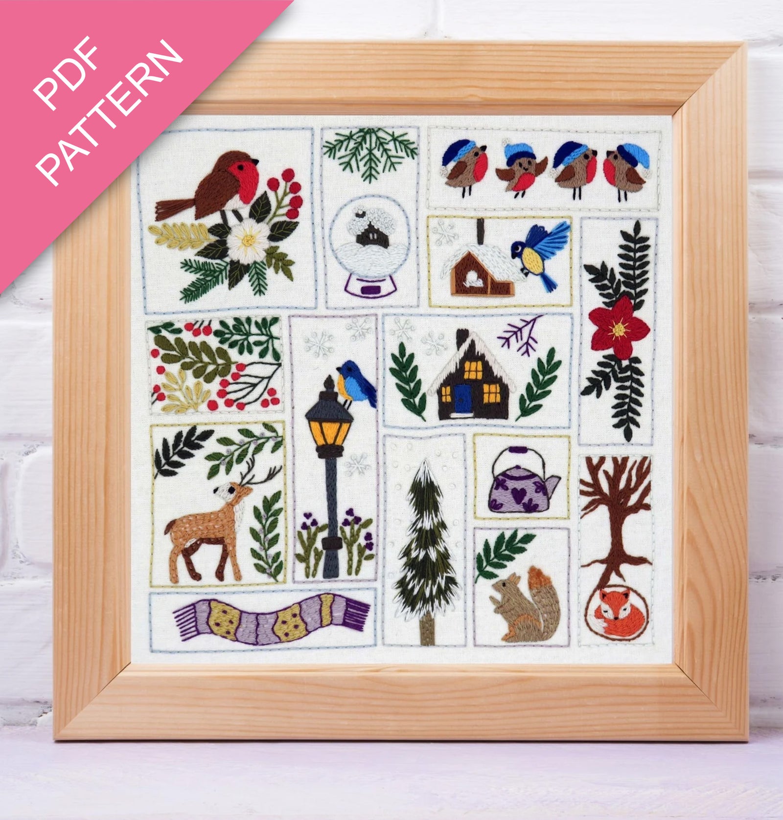 Framed cross-stitch pattern with various designs including birds, flowers, and animals on a white background.