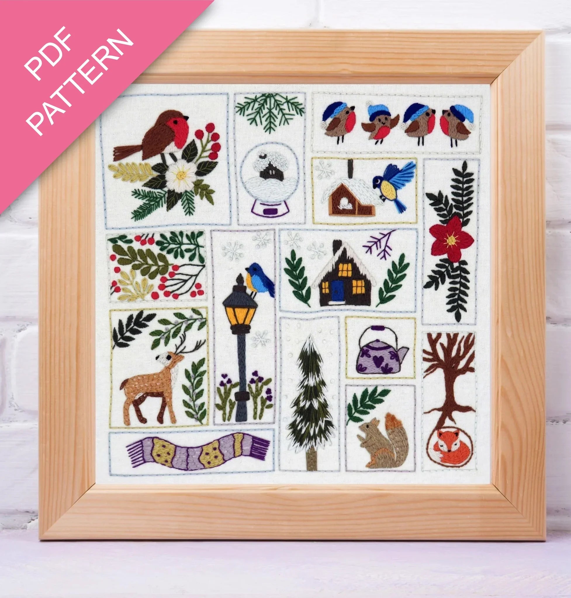 Framed cross-stitch pattern with various designs including birds, flowers, and animals on a white background.