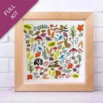 Framed artwork with nature-themed designs on a white brick wall background