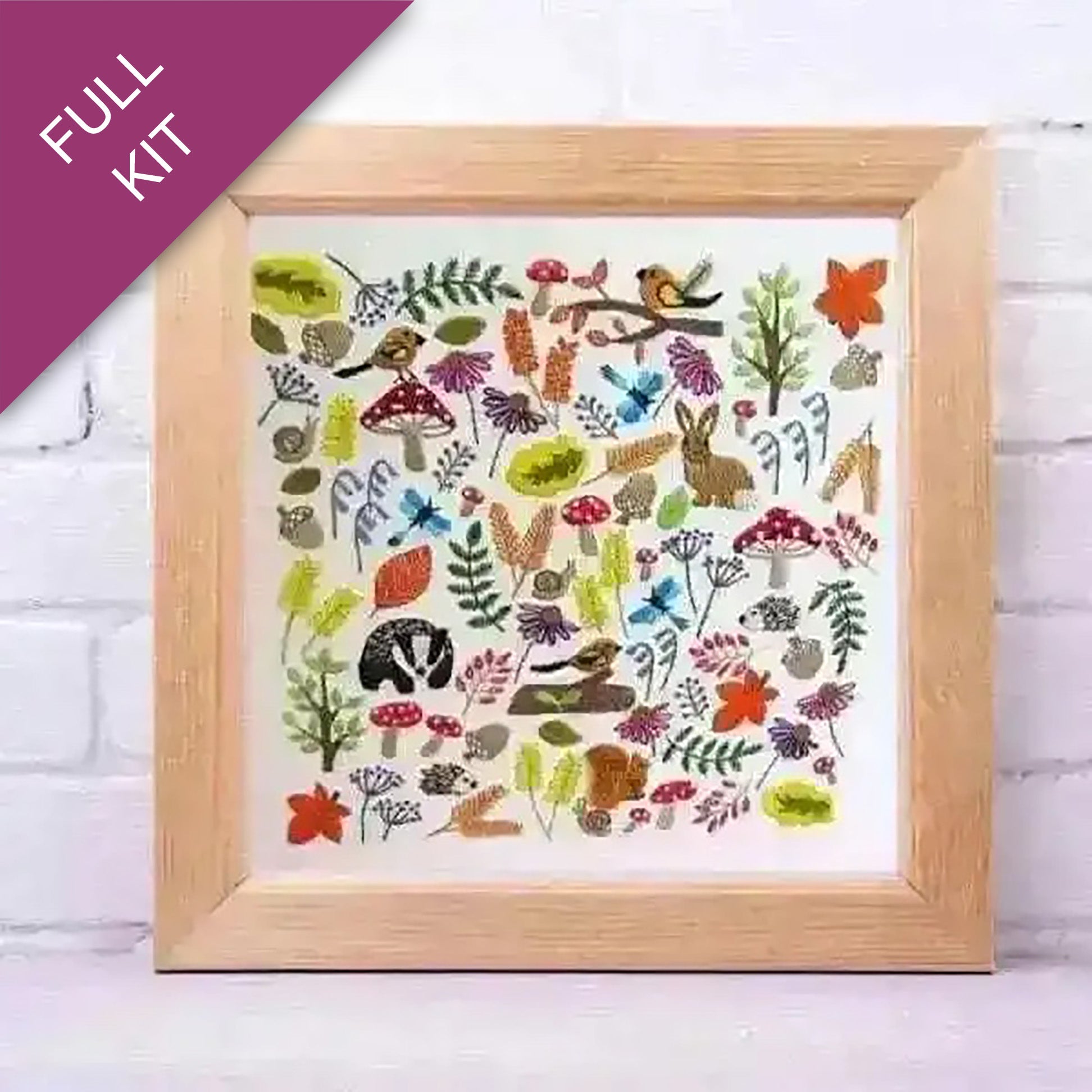 Framed artwork with nature-themed designs on a white brick wall background
