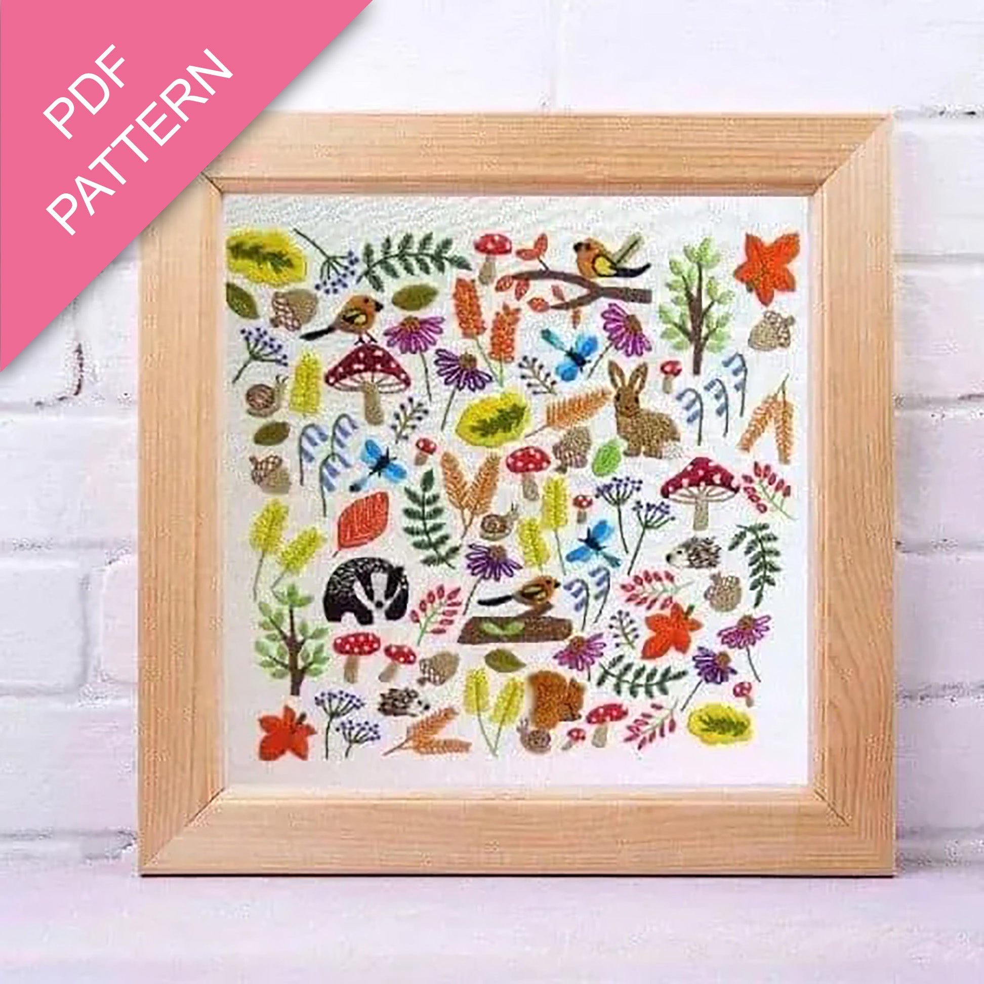 Framed embroidery pattern with nature-themed designs a walk in the woods theme