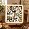 Embroidered pattern with animals, trees, and flowers on a white background