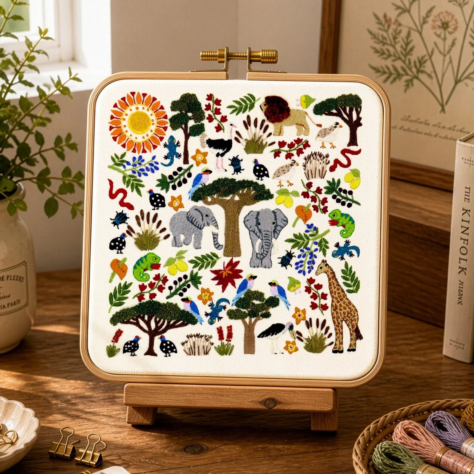 Embroidered pattern with animals, trees, and flowers on a white background