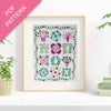 Framed floral pattern on a white wall with plants and books in the background