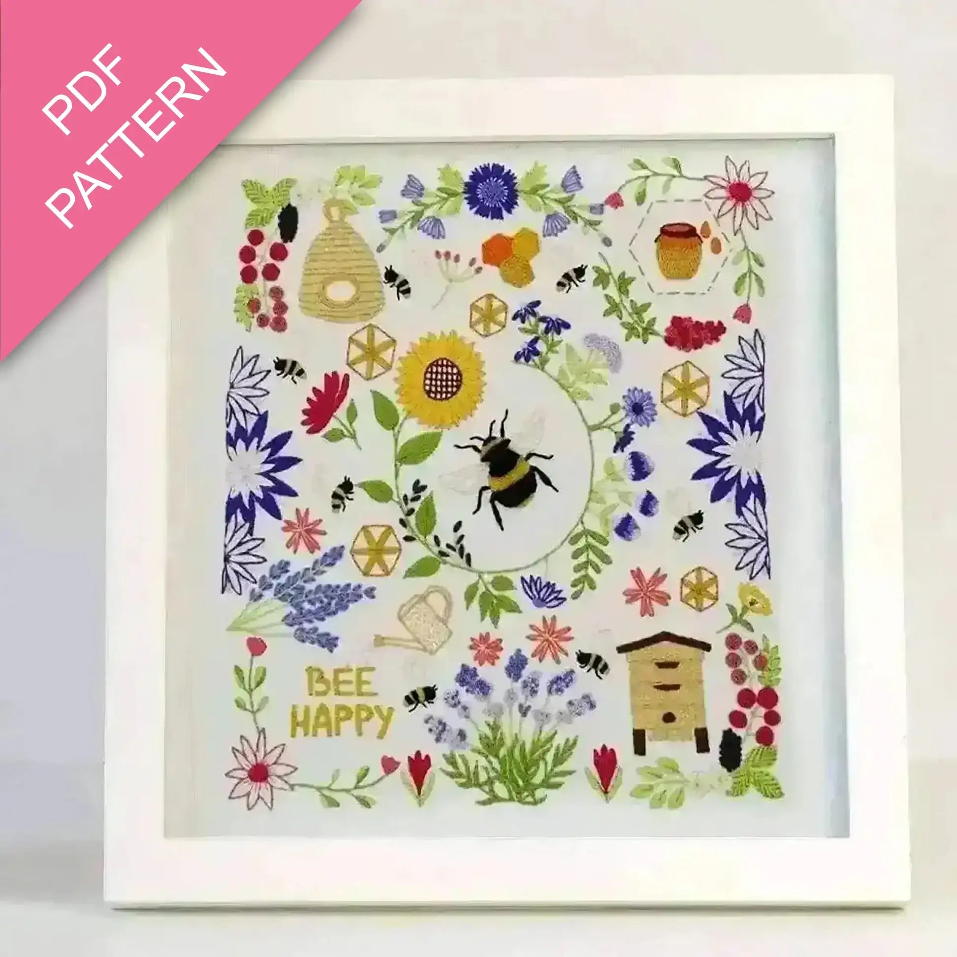 Colorful embroidery pattern with bees, flowers, and 'Bee Happy' text on a white background.