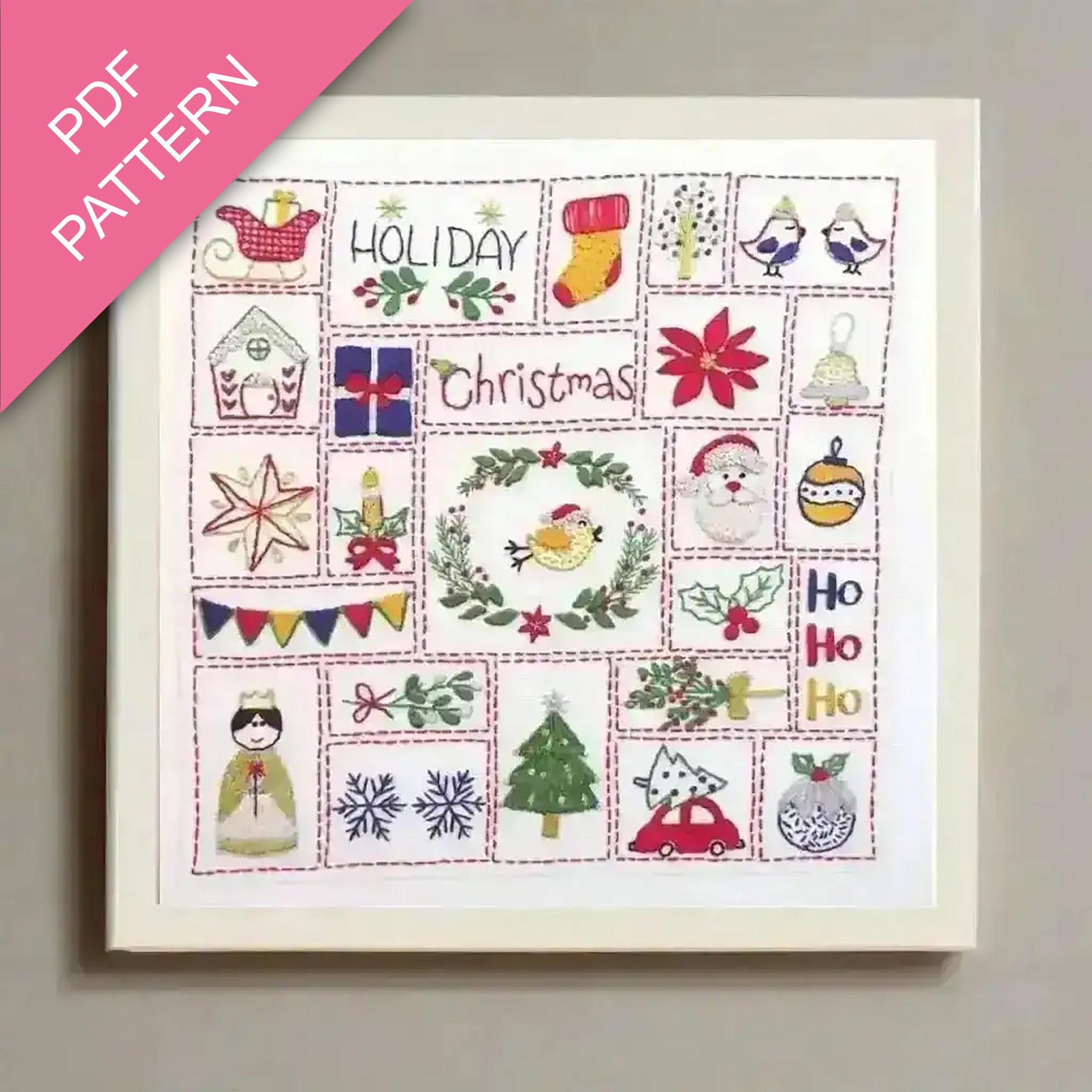 Framed cross-stitch pattern with Christmas-themed designs on a light gray background.