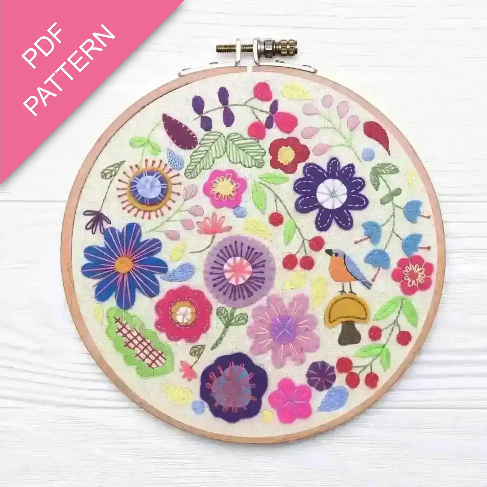 Embroidery hoop with colorful floral design on a white background