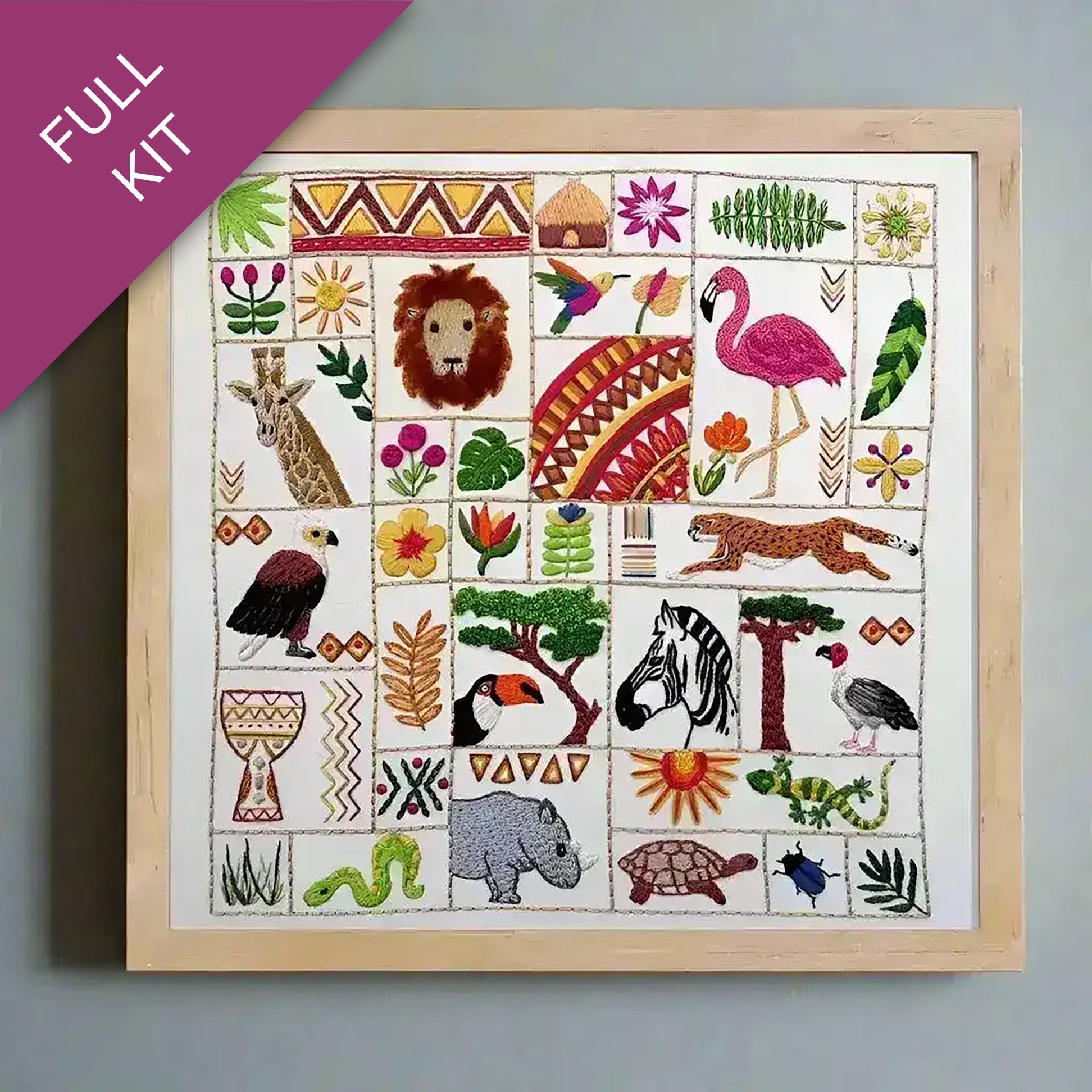 Embroidery kit with pre-designed patterns of animals and plants on a white fabric background.