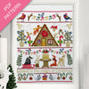 Christmas-themed cross-stitch pattern with a cabin, animals, and festive elements on a white background.