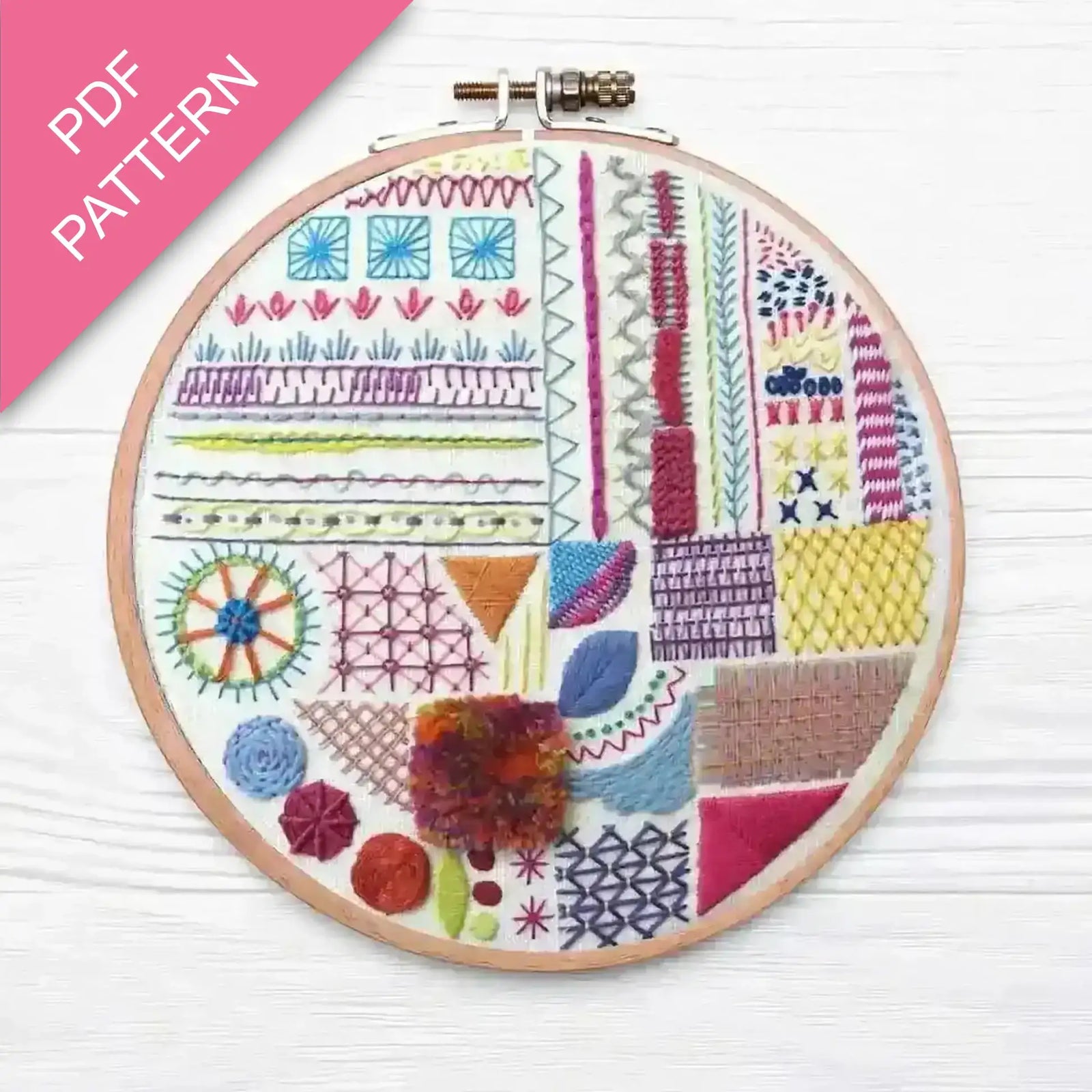 Embroidery hoop with colorful patterns on a white background, featuring the text 'PDF Pattern' on a pink banner.
