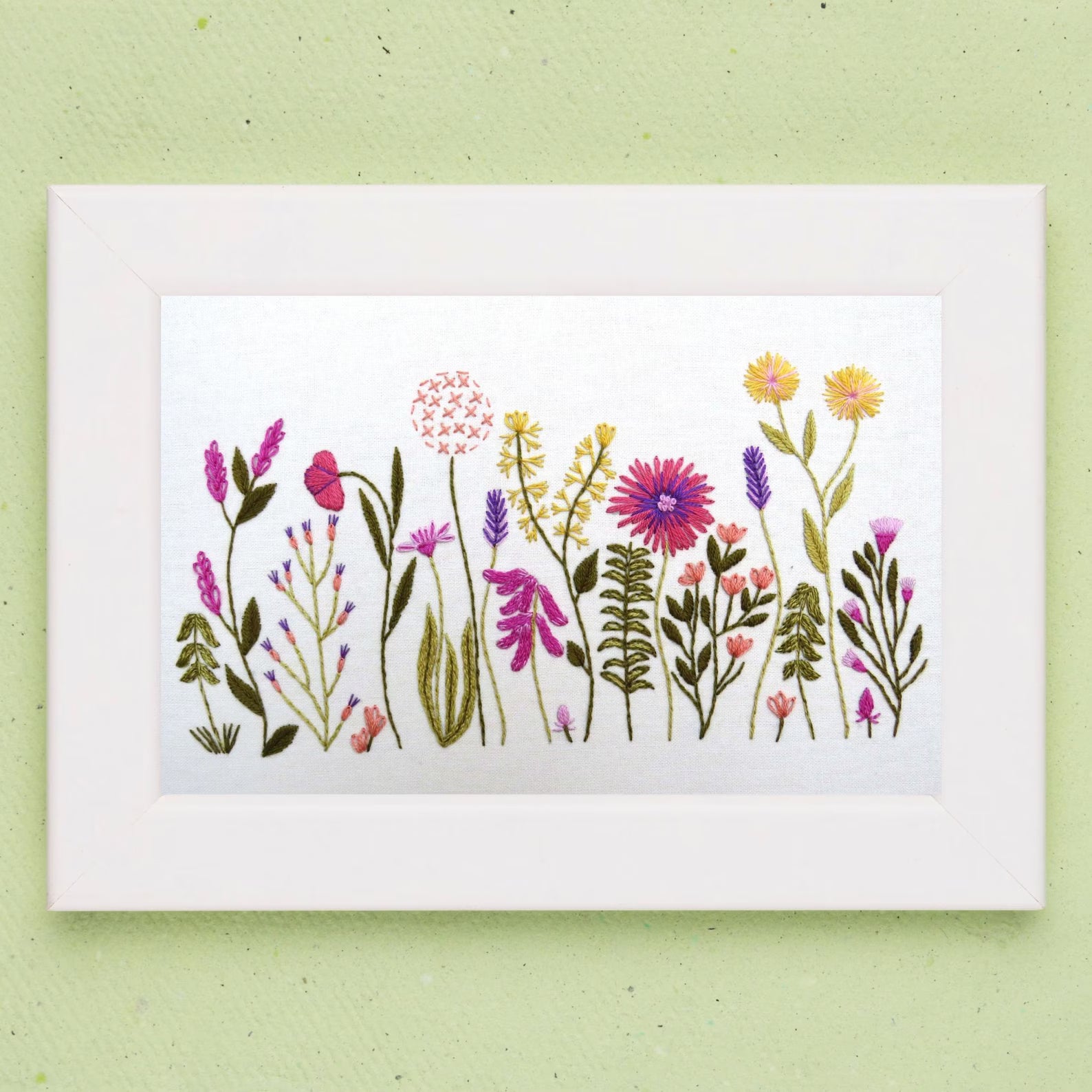 Card with watercolor illustration of various flowers on a light green background