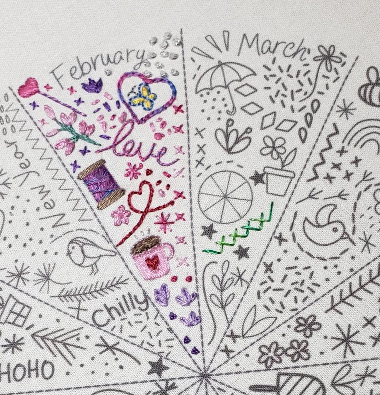 Embroidery design with months and decorative elements on a white background