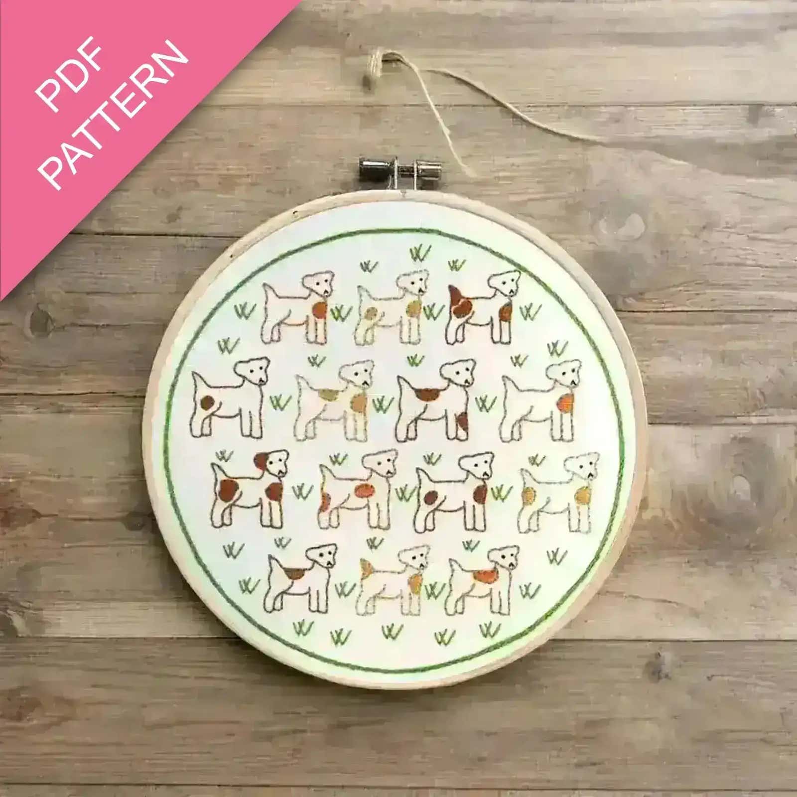 Embroidery hoop with dog pattern on a wooden surface, labeled 'PDF Pattern'.
